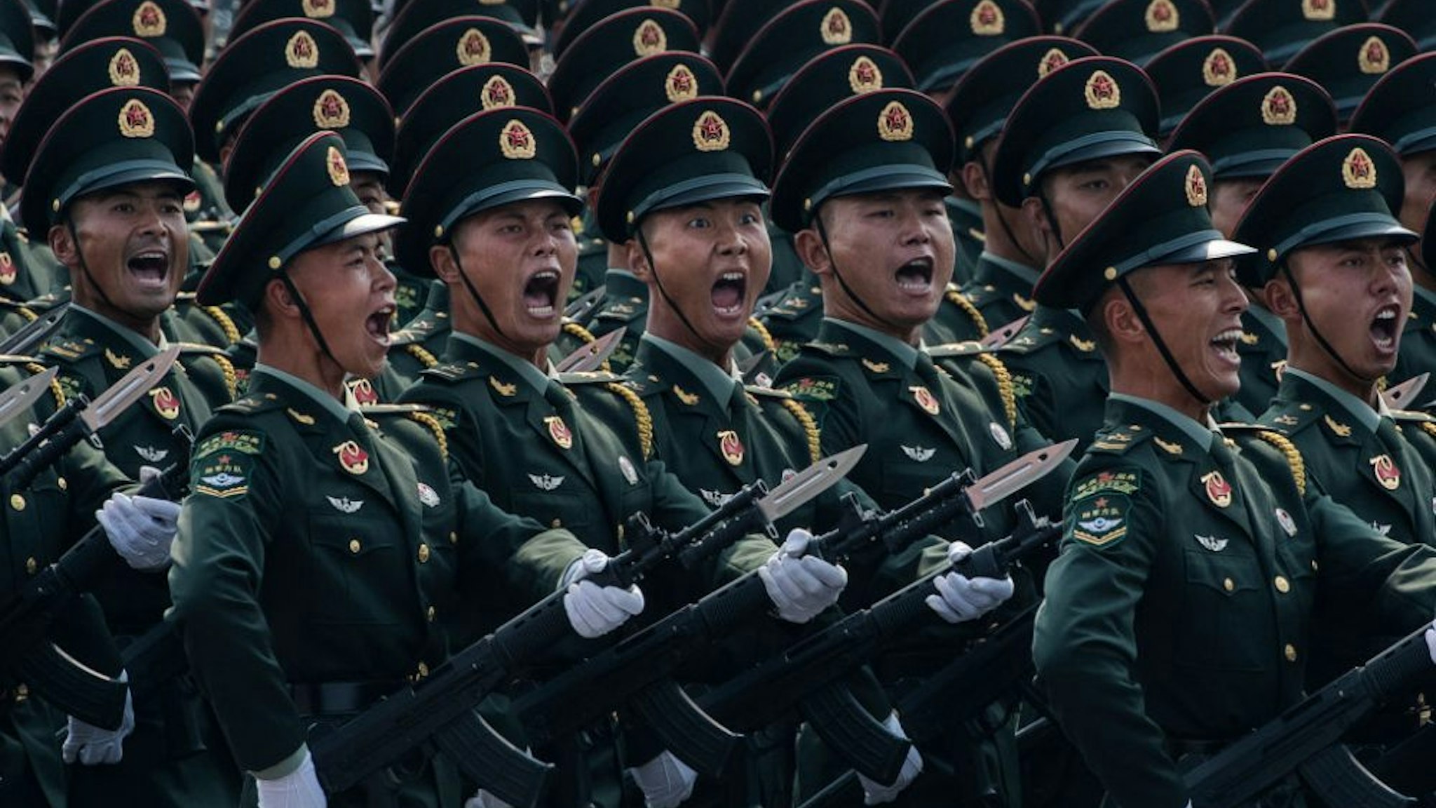 BEIJING, CHINA - OCTOBER 01: Chinese soldiers shout as they march in formation during a parade to celebrate the 70th Anniversary of the founding of the People's Republic of China at Tiananmen Square in 1949, on October 1, 2019 in Beijing, China.