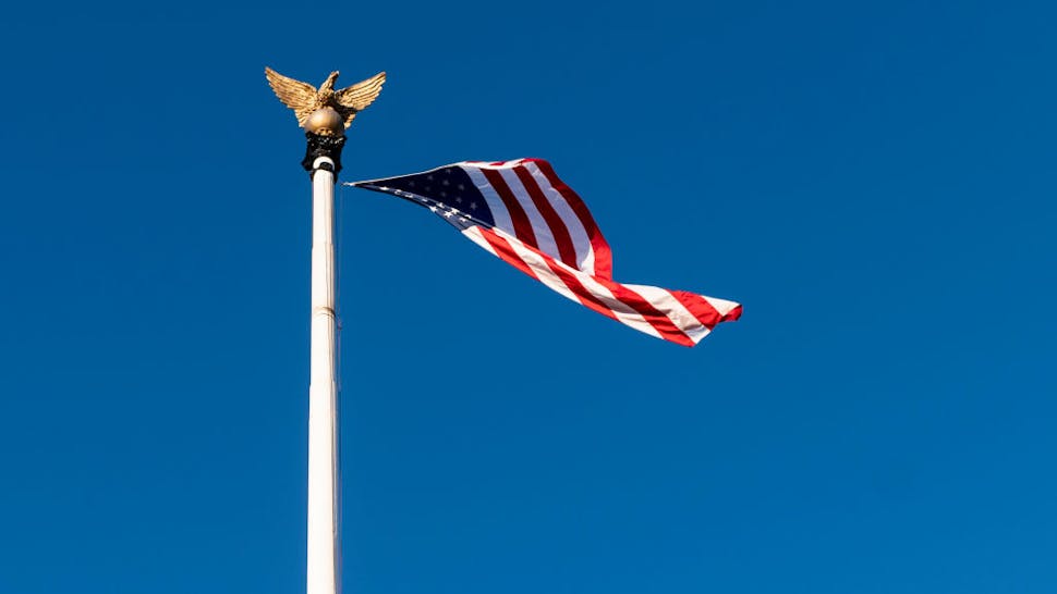 UNITED STATES – DECEMBER 8: An American flag hangs upside down in the wind outside Union Station in Washington on Tuesday, Dec. 8, 2020. UNITED STATES - DECEMBER 8: An American flag hangs upside down in the wind outside Union Station in Washington on Tuesday, Dec. 8, 2020.