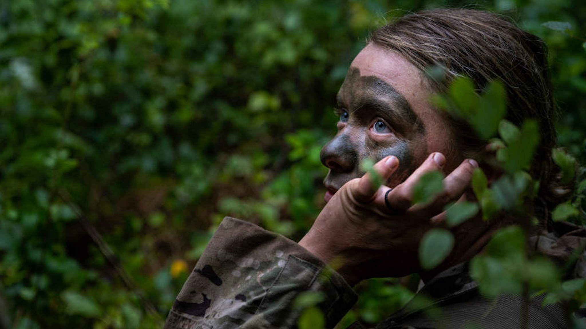 A cadet of the 3rd Regiment listens to a nearby speaking cadet in Training Area 9 during Army ROTC Cadet Summer Training on July 1, 2021 in Fort Knox, Kentucky.