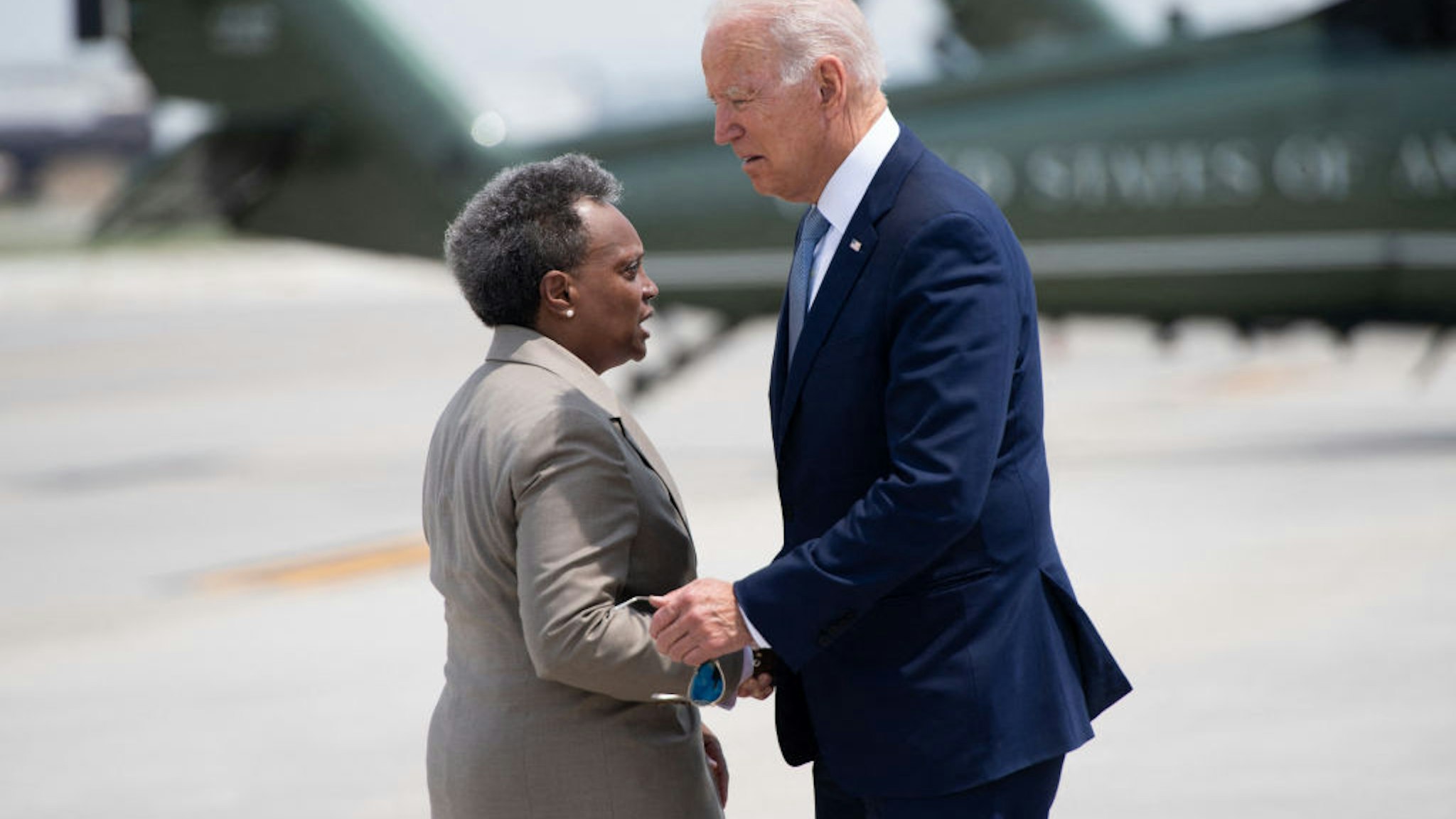 US President Joe Biden greets Chicago Mayor Lori Lightfoot (L) as he disembarks from Air Force One upon arrival at O'Hare International Airport in Chicago, Illinois, July 7, 2021, as he travels to promote his economic plans in Illinois. (Photo by SAUL LOEB / AFP) (Photo by SAUL LOEB/AFP via Getty Images)