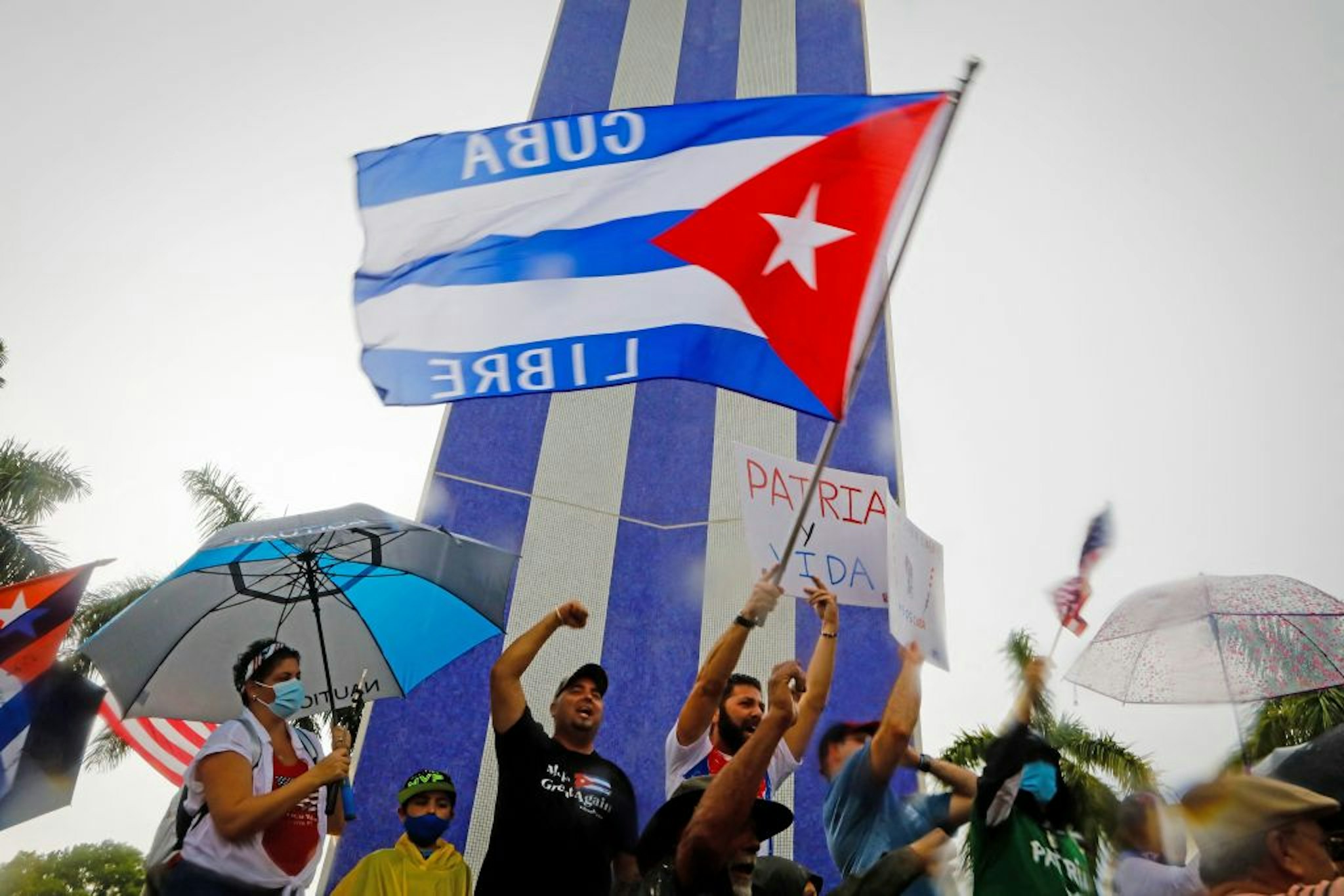 People demonstrate waving Cuban flags during a protest against the Cuban government at Tamiami Park in Miami, on July 13, 2021. - Washington warned Haitians and Cubans against trying to flee to the United States as they endure domestic unrest, saying the trip is dangerous and they would be repatriated. (Photo by Eva Marie UZCATEGUI / AFP) (Photo by EVA MARIE UZCATEGUI/AFP via Getty Images)