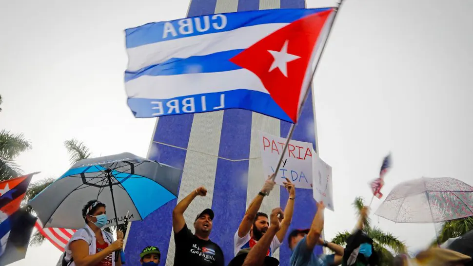 People demonstrate waving Cuban flags during a protest against the Cuban government at Tamiami Park in Miami, on July 13, 2021. - Washington warned Haitians and Cubans against trying to flee to the United States as they endure domestic unrest, saying the trip is dangerous and they would be repatriated. (Photo by Eva Marie UZCATEGUI / AFP) (Photo by EVA MARIE UZCATEGUI/AFP via Getty Images)