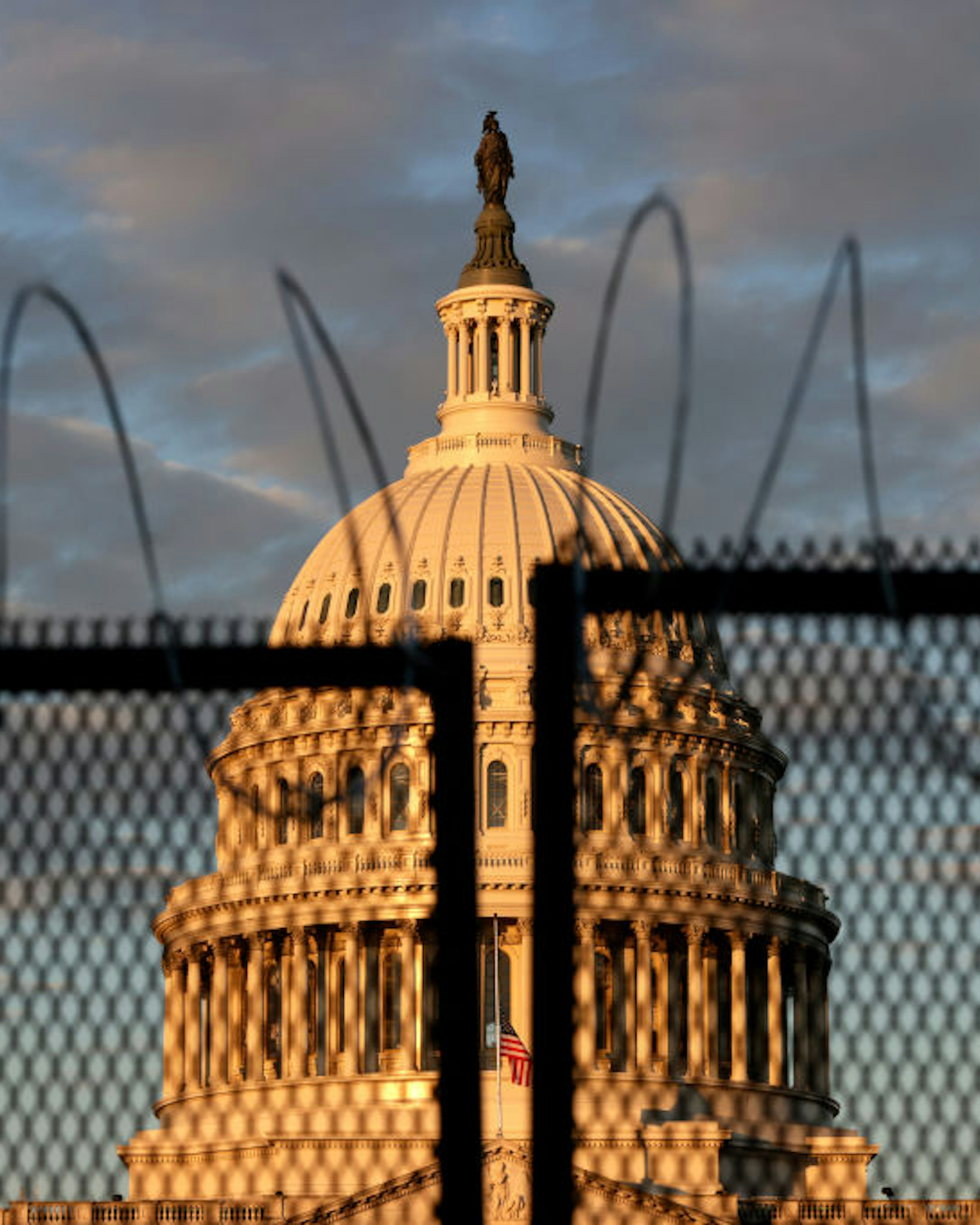 WASHINGTON, DC - JANUARY 16: The U.S. Capitol is seen behind a fence with razor wire during sunrise on January 16, 2021 in Washington, DC. After last week's riots at the U.S. Capitol Building, the FBI has warned of additional threats in the nation's capital and in all 50 states. According to reports, as many as 25,000 National Guard soldiers will be guarding the city as preparations are made for the inauguration of Joe Biden as the 46th U.S. President. (Photo by Samuel Corum/Getty Images)