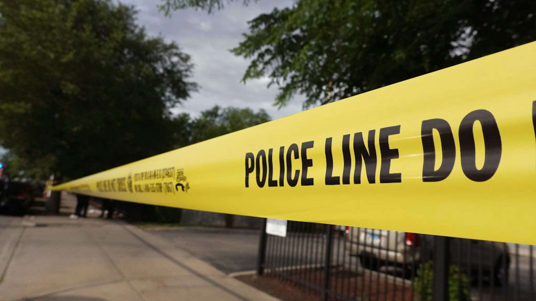 CHICAGO, ILLINOIS - JUNE 23: Police tape surrounds a crime scene where three people were shot at the Wentworth Gardens housing complex in the Bridgeport neighborhood on June 23, 2021 in Chicago, Illinois. A 24-year-old man died from injuries he suffered in the shooting and two others, a 22-year-old male and a 25-year-old male, were seriously wounded. (Photo by Scott Olson/Getty Images)
