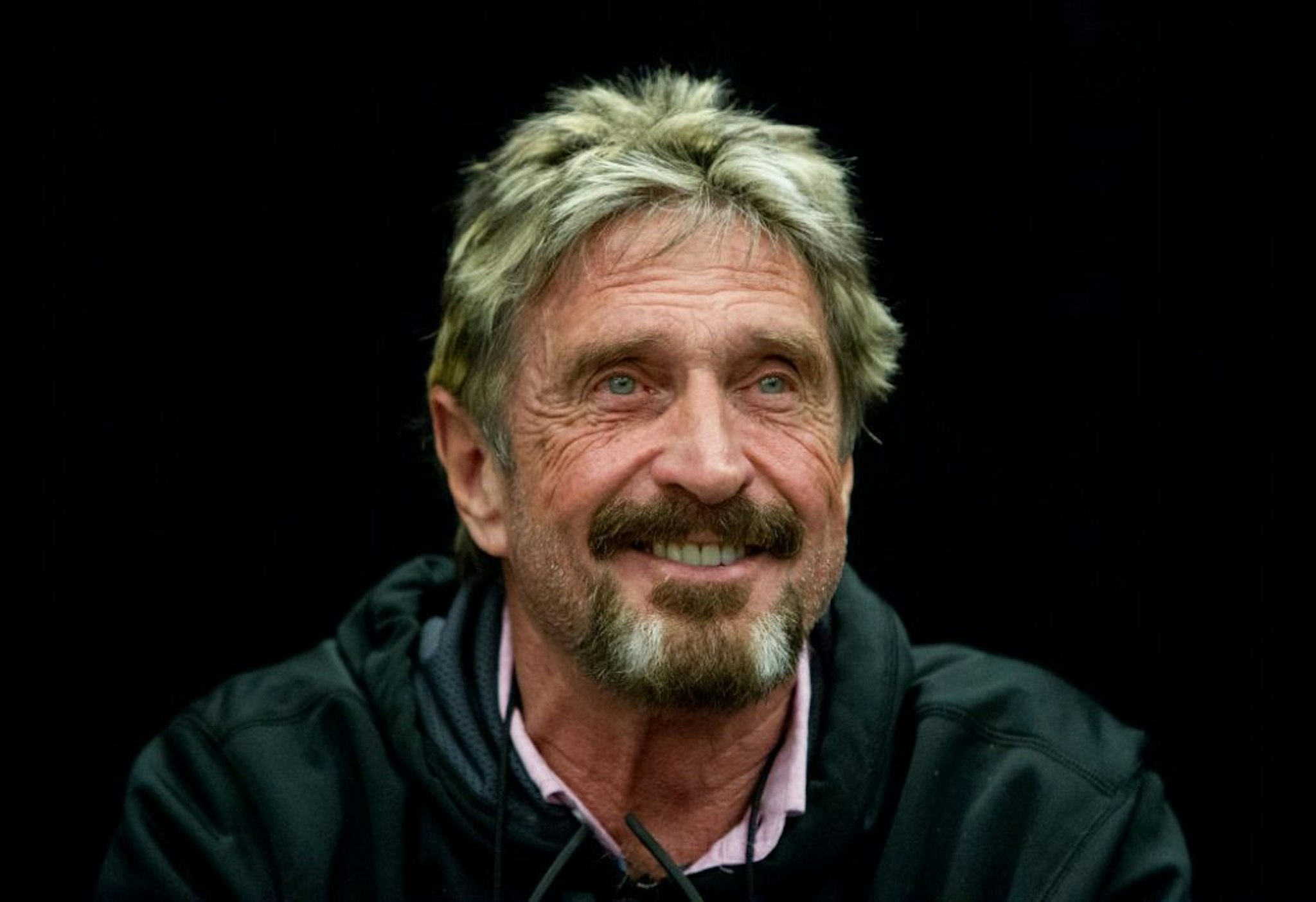 SAN JOSE, CALIFORNIA - SEPTEMBER 28: John McAfee reacts to a question at the "Fireside Chat with John McAfee" talk during the C2SV Technology Conference + Music Festival at the McEnery Convention Center in San Jose, Calif., on Saturday, Sept. 28, 2013.