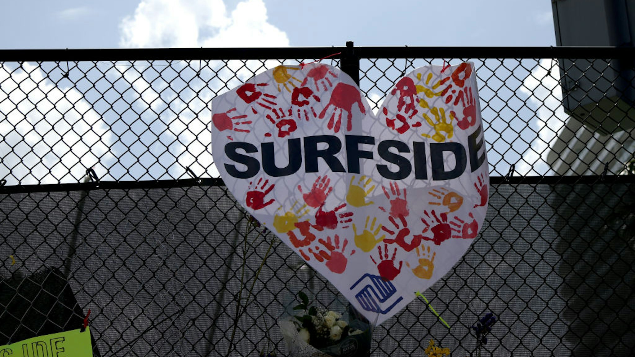 URFSIDE, FLORIDA - JULY 08: Signs are placed near the memorial site for victims of the collapsed 12-story Champlain Towers South condo building on July 08, 2021 in Surfside, Florida. With the death toll currently at 60 and 80 people still missing, rescue workers have shifted the operation to recovery efforts. (Photo by Anna Moneymaker/Getty Images)