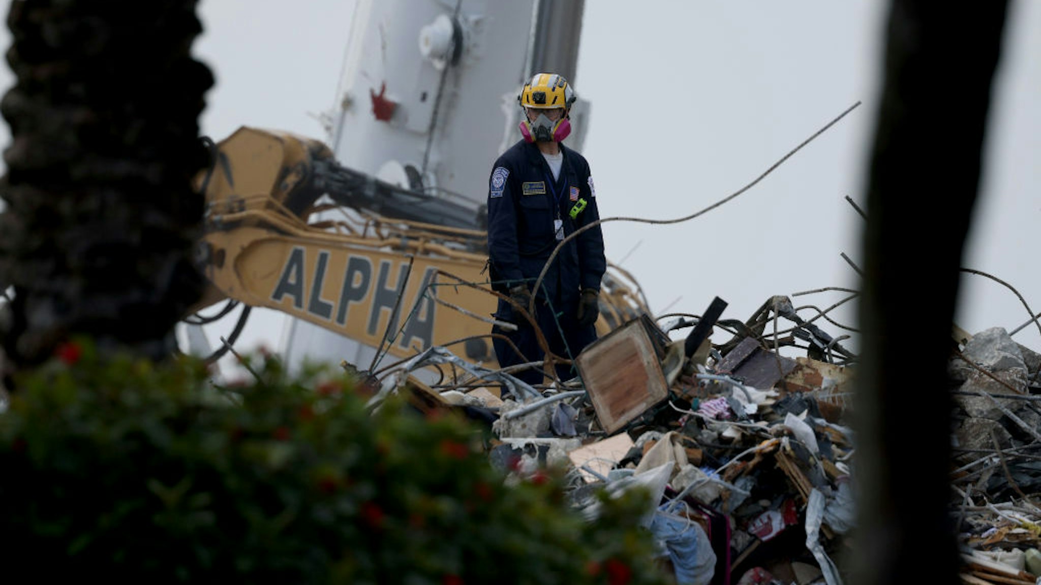 A rescue worker works on top of the collapsed 12-story Champlain Towers South condo building on July 10, 2021 in Surfside, Florida.