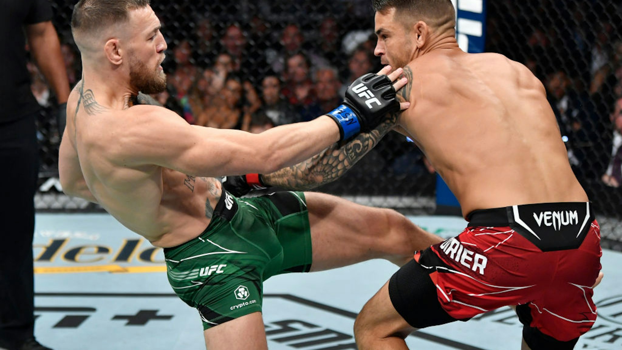 LAS VEGAS, NEVADA - JULY 10: (L-R) Conor McGregor of Ireland kicks Dustin Poirier in their welterweight fight during the UFC 264 event at T-Mobile Arena on July 10, 2021 in Las Vegas, Nevada. (Photo by Jeff Bottari/Zuffa LLC)
