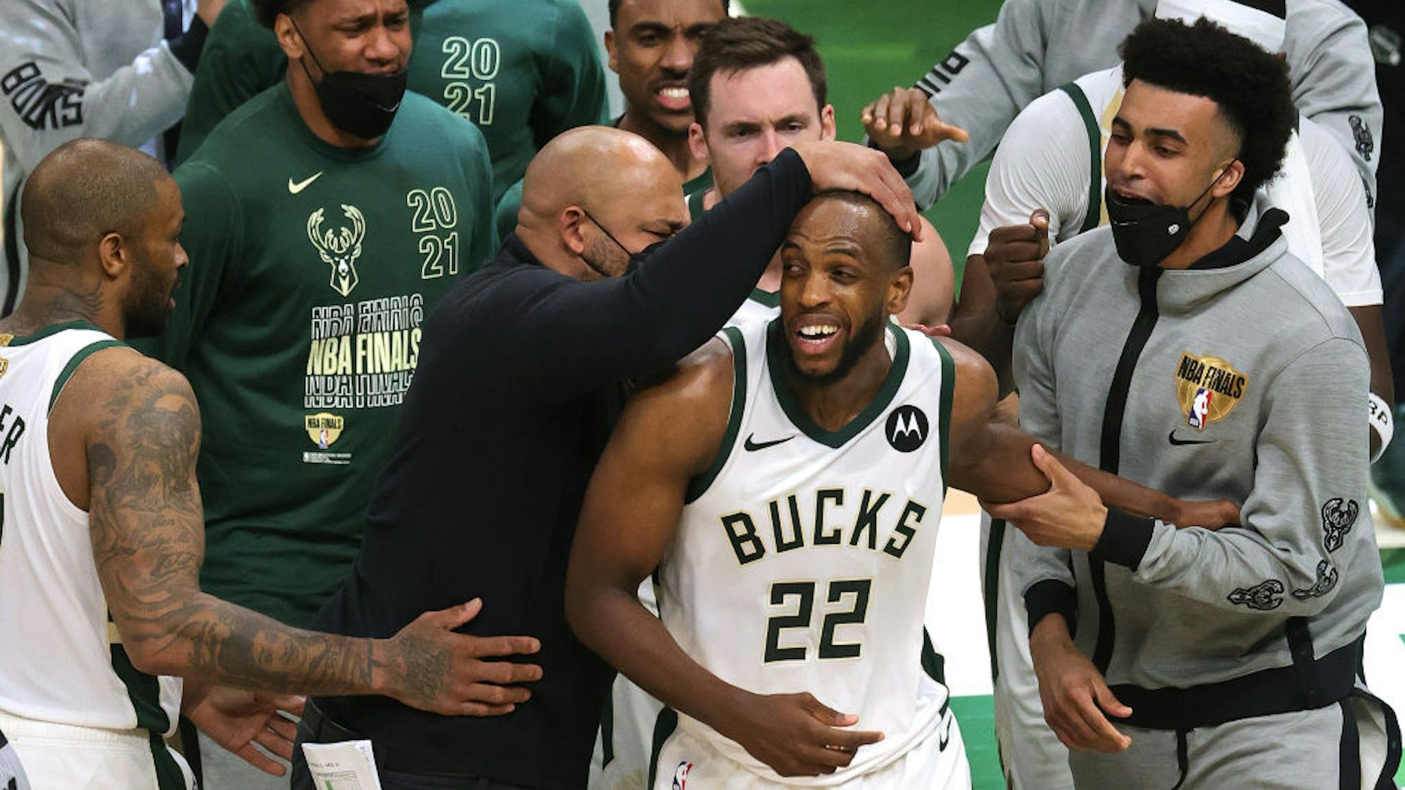 MILWAUKEE, WISCONSIN - JULY 14: Khris Middleton #22 of the Milwaukee Bucks is congratulated by teammates during the second half in Game Four of the NBA Finals against the Phoenix Suns at Fiserv Forum on July 14, 2021 in Milwaukee, Wisconsin. NOTE TO USER: User expressly acknowledges and agrees that, by downloading and or using this photograph, User is consenting to the terms and conditions of the Getty Images License Agreement. (Photo by Jonathan Daniel/Getty Images)