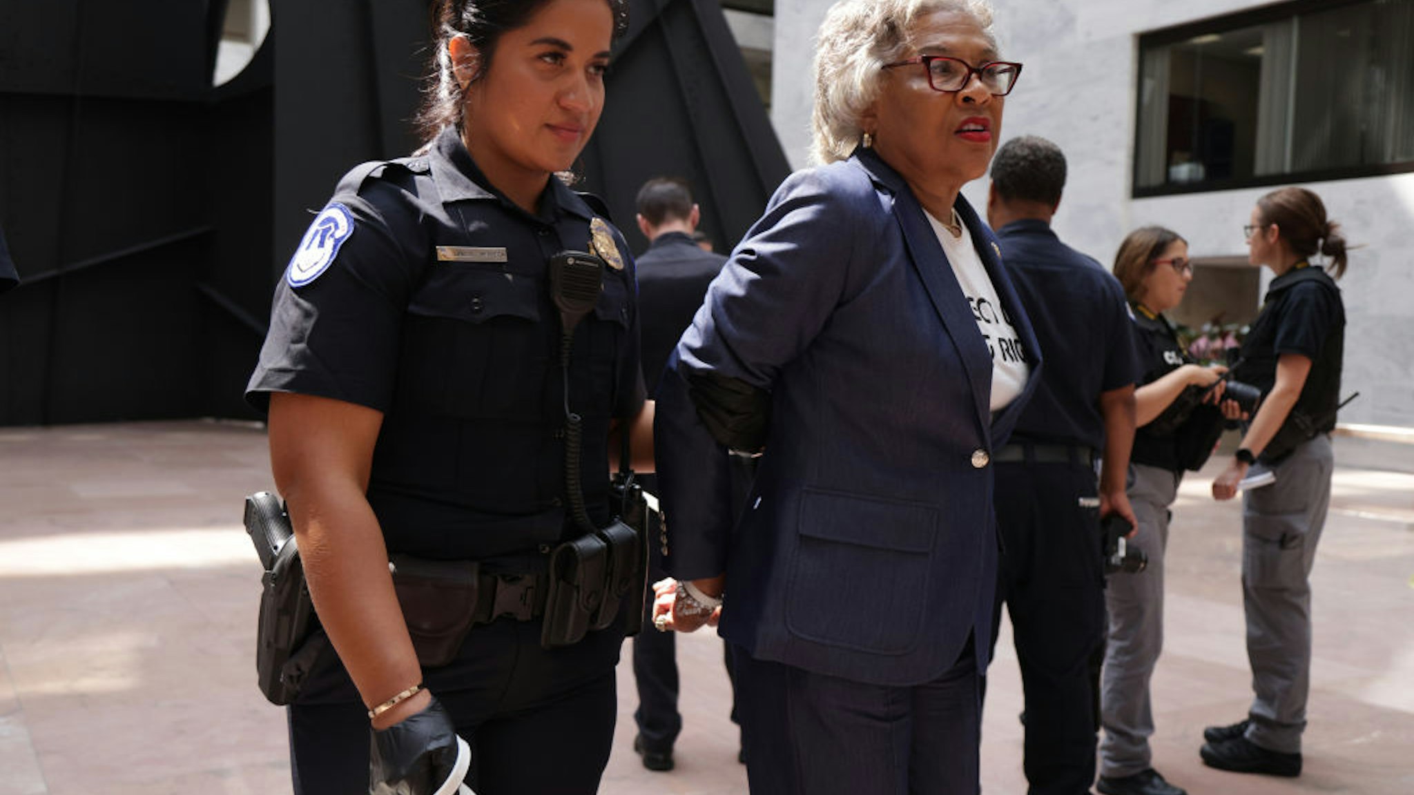 WASHINGTON, DC - JULY 15: U.S. Rep. Joyce Beatty (D-OH) (2nd L) and Chair of Congressional Black Caucus (CBC), is led away by a member of the U.S. Capitol Police during a protest at Hart Senate Office Building July 15, 2021 on Capitol Hill in Washington, DC.