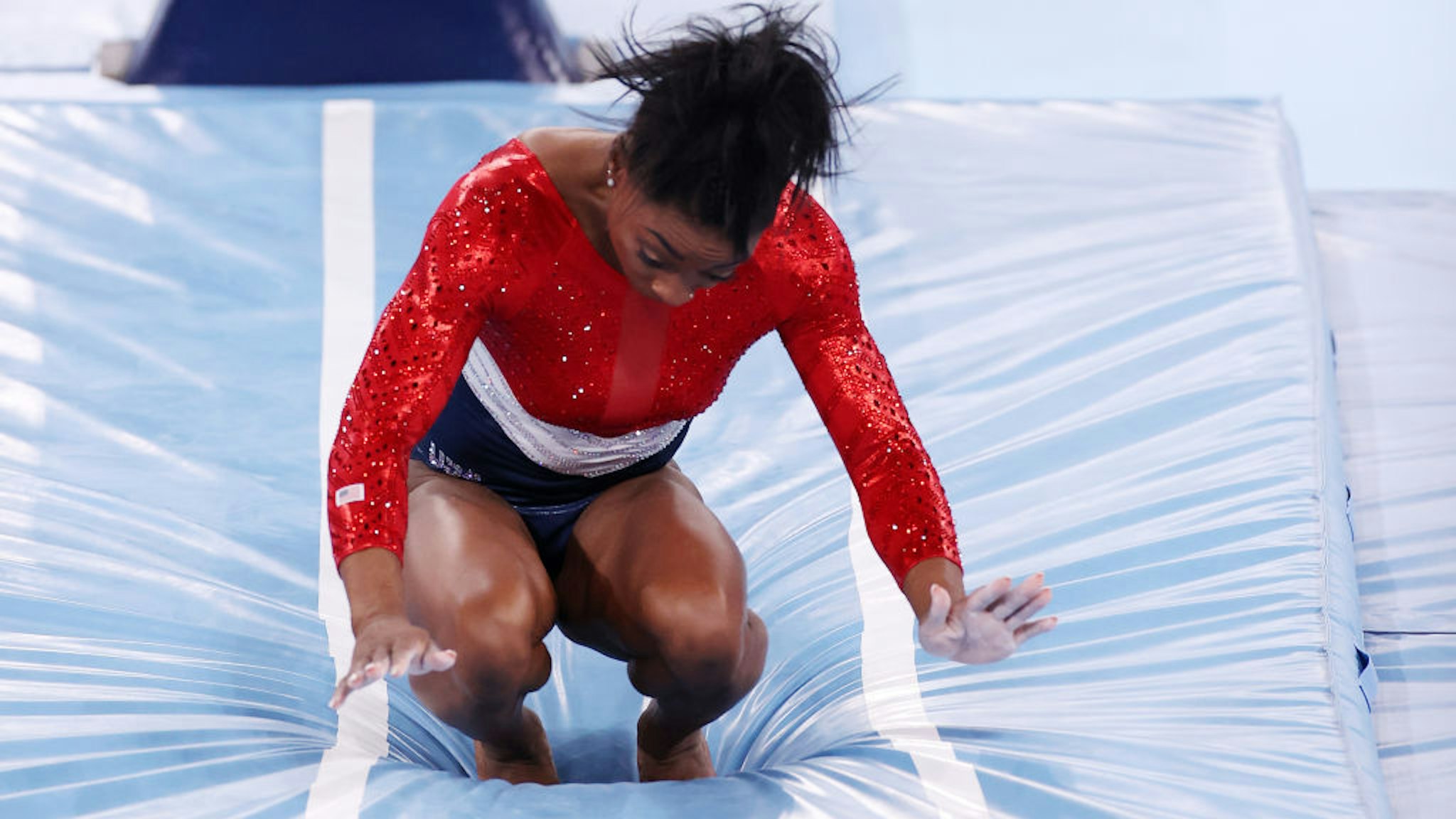 TOKYO, JAPAN - JULY 27: Simone Biles of Team United States stumbles upon landing after competing in vault during the Women's Team Final on day four of the Tokyo 2020 Olympic Games at Ariake Gymnastics Centre on July 27, 2021 in Tokyo, Japan. (Photo by Jamie Squire/Getty Images)