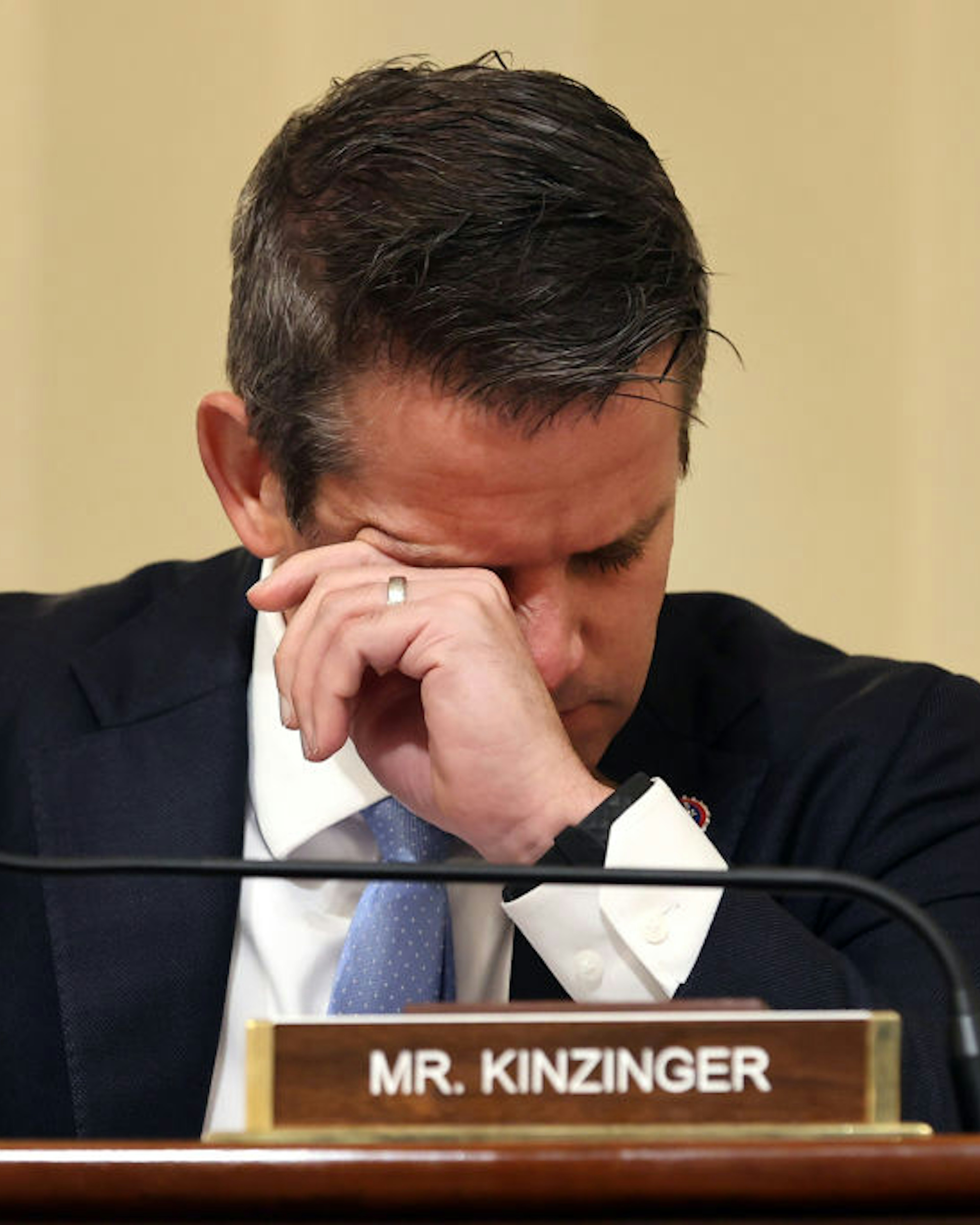 WASHINGTON, DC - JULY 27: U.S. Rep. Adam Kinzinger (R-IL) wipes his eyes as he listens to testimony during a hearing by the House Select Committee investigating the January 6 attack on the U.S. Capitol on July 27, 2021 at the Cannon House Office Building in Washington, DC. Members of law enforcement testified about the attack by supporters of former President Donald Trump on the U.S. Capitol. According to authorities, about 140 police officers were injured when they were trampled, had objects thrown at them, and sprayed with chemical irritants during the insurrection. (Photo by Chip Somodevilla/Getty Images)