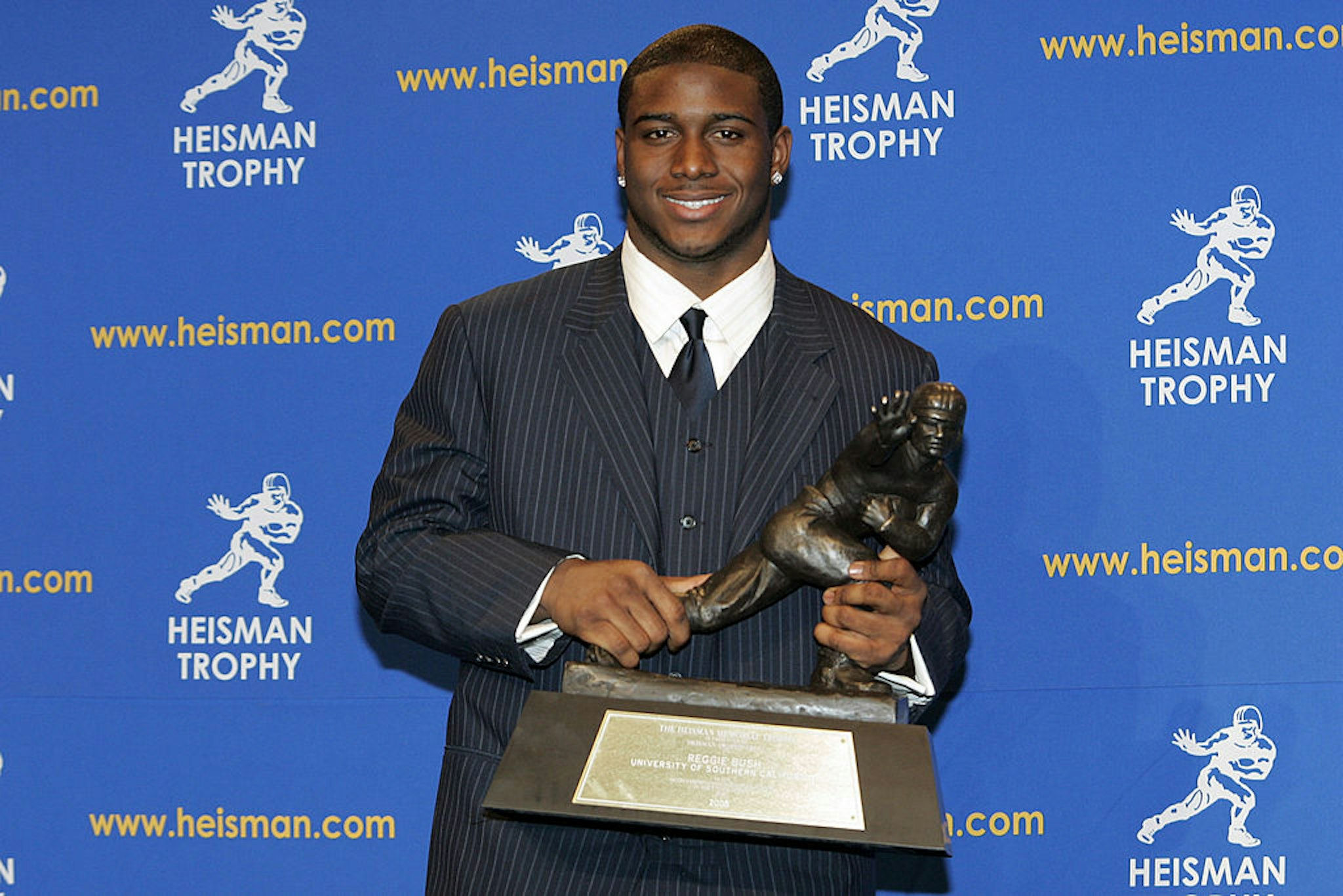 Reggie Bush, University of Southern California tailback holds the Heisman Trophy during the 2005 Heisman Trophy presentation at the Hard Rock Cafe in New York City, New York on December 10, 2005. Bush received 2,541 points in the ballot. (Photo by Michael Cohen/WireImage)