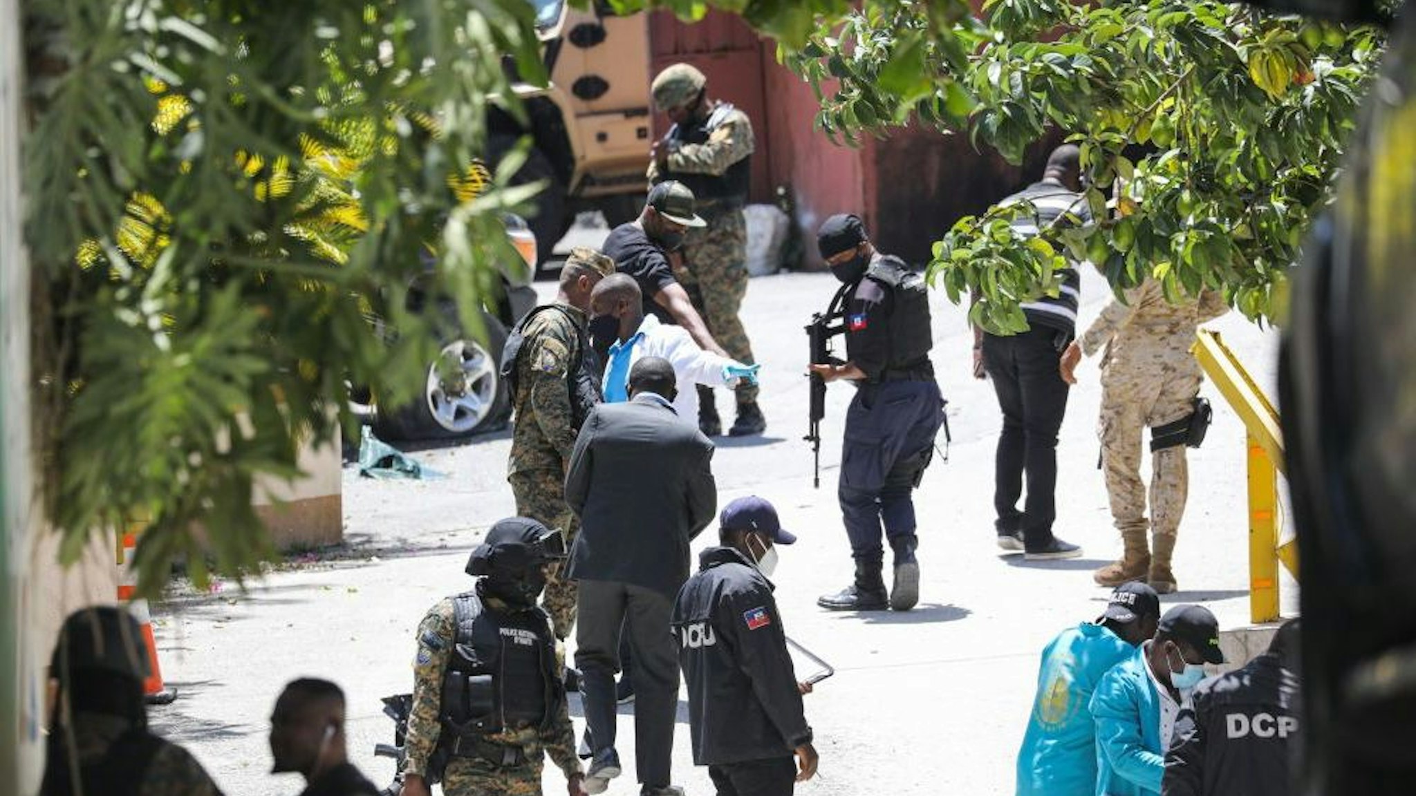 Members of the Haitian police and forensics look for evidence outside of the presidential residence on July 7, 2021 in Port-au-Prince, Haiti. - Haiti President Jovenel Moise was assassinated and his wife wounded early July 7, 2021 in an attack at their home, the interim prime minister announced, an act that risks further destabilizing the Caribbean nation beset by gang violence and political volatility. Claude Joseph said he was now in charge of the country and urged the public to remain calm, while insisting the police and army would ensure the population's safety.The capital Port-au-prince as quiet on Wednesday morning with no extra security forces on patrol, witnesses reported.