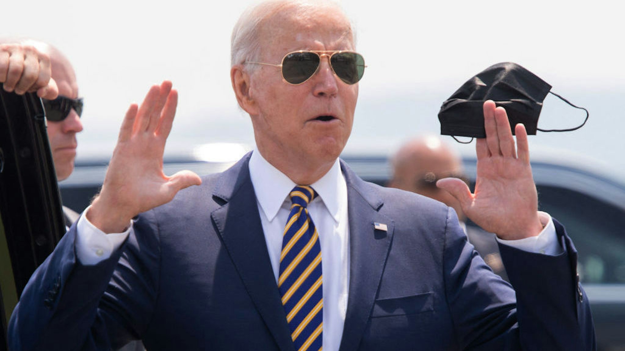 US President Joe Biden answers a question from the press as he holds a mask upon arrival on Air Force One at Lehigh Valley International Airport in Allentown, Pennsylvania, July 28, 2021, as he travels to speak on the economy. (Photo by SAUL LOEB / AFP) (Photo by SAUL LOEB/AFP via Getty Images)