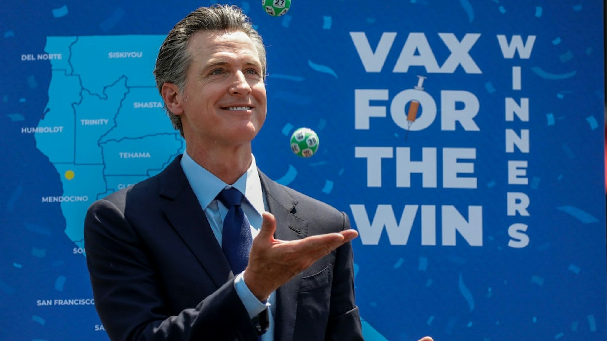 Universal City, CA - June 15: Gov. Gavin Newsom juggles numbered balls used in a lottery-style give away, following the conclusion of a press conference celebrating Californias full reopening, marking the end of pandemic-era restrictions like masks, social distancing and most capacity restrictions, at Universal Studios, in Universal City, CA, Tuesday, June 15, 2021.
