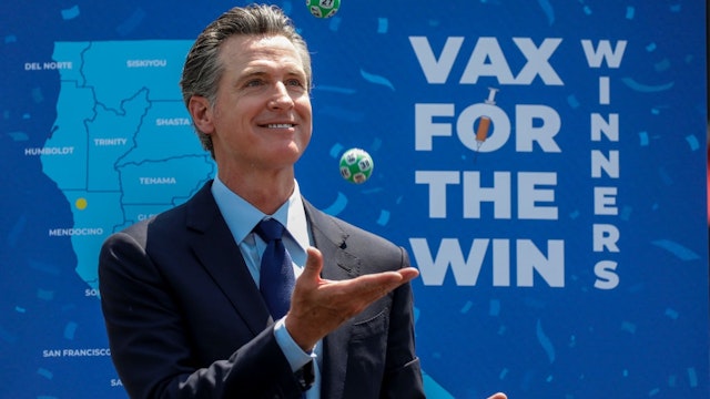 Universal City, CA - June 15: Gov. Gavin Newsom juggles numbered balls used in a lottery-style give away, following the conclusion of a press conference celebrating Californias full reopening, marking the end of pandemic-era restrictions like masks, social distancing and most capacity restrictions, at Universal Studios, in Universal City, CA, Tuesday, June 15, 2021.