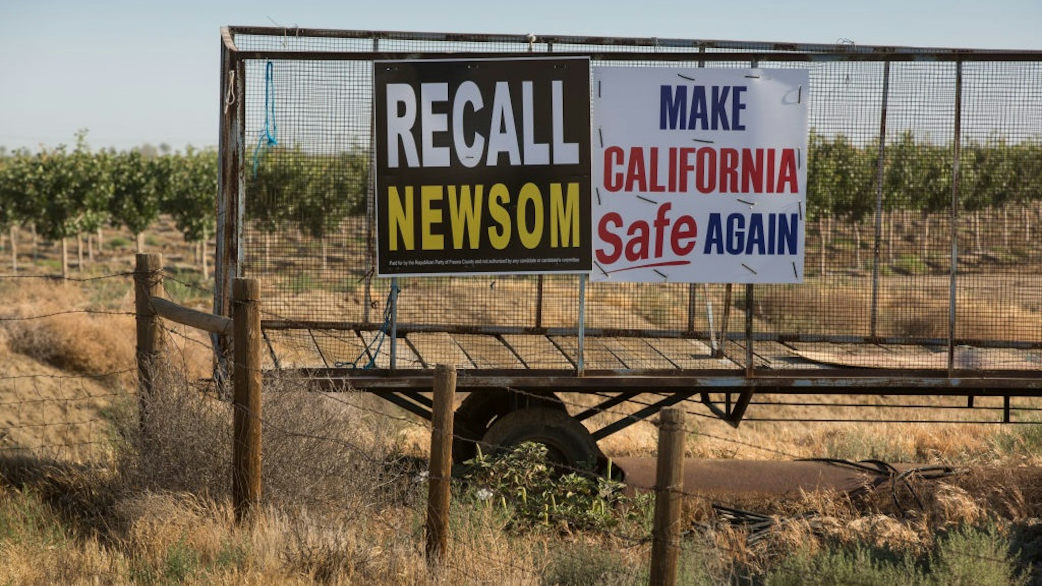 GUSTINE, CA - MAY 31: A "Recall Newsom" and "Make California Safe Again" political sign is planted in a barren field along Interstate 5 as viewed on May 31, 2021, near Gustine, California.