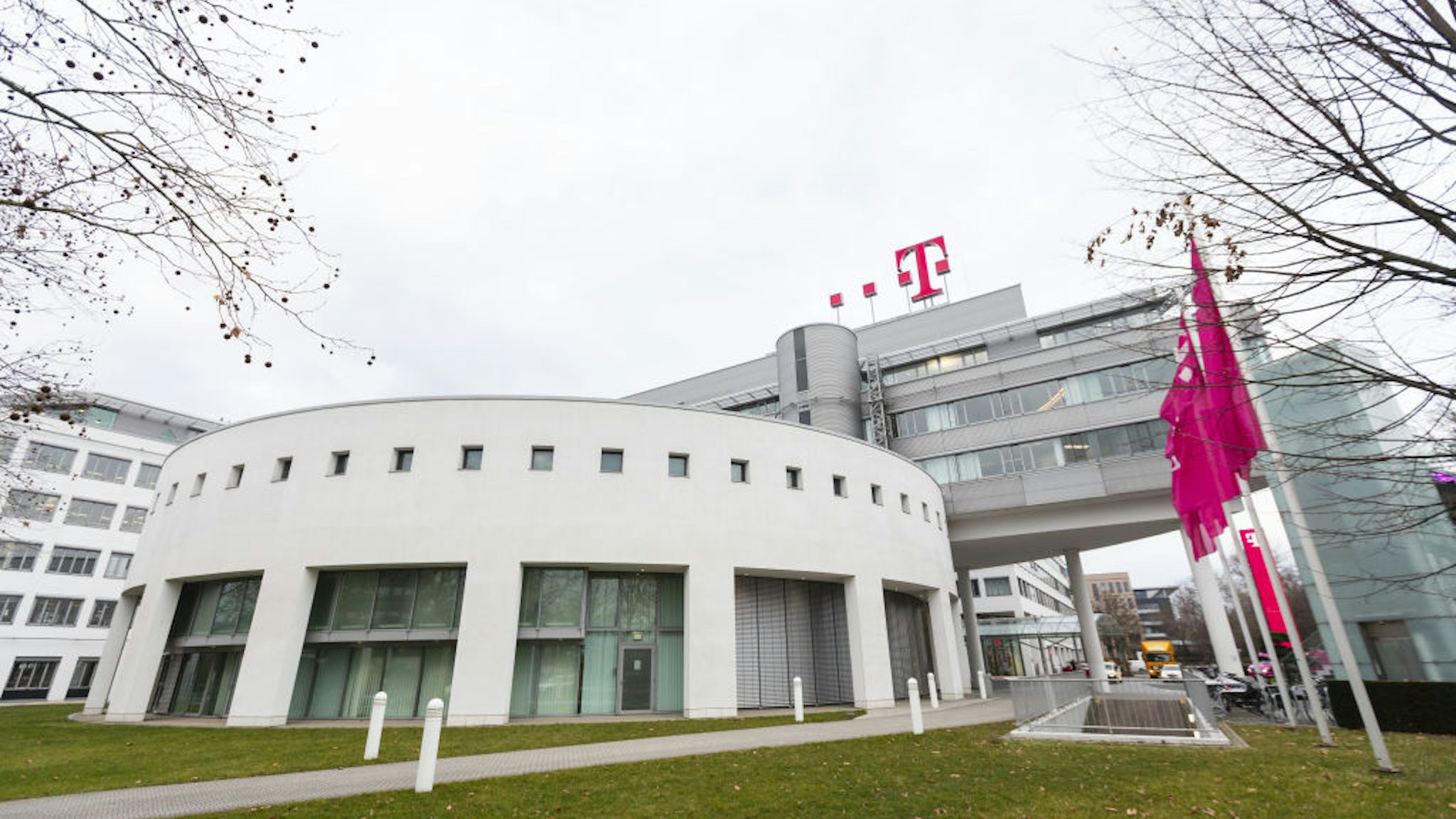 The T-Mobile logo sits on top of the Deutsche Telekom AG headquarters in Bonn, Germany, on Thursday, Feb. 21, 2019. Deutsche Telekom's forecast for 2019 earnings fell short of analysts' estimates as Europes largest phone carrier prepares to spend billions on wireless spectrum and building 5G networks in the face of rising regional competition.