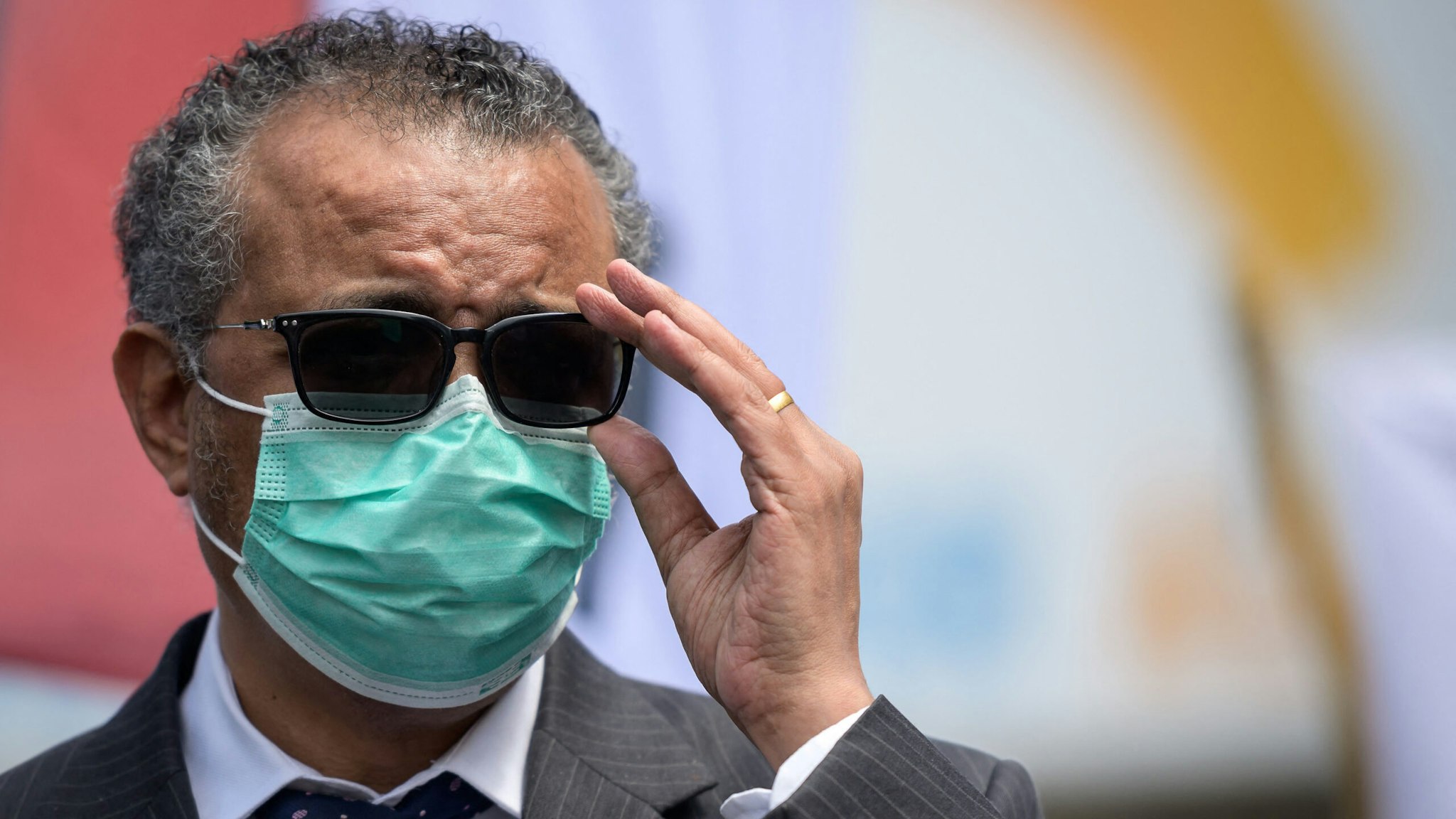 World Health Organization (WHO) Director-General Tedros Adhanom Ghebreyesus adjusts his glasses during a meeting with Doctors for Extinction Rebellion in front of the WHO headquarters during a protest on the sideline of the WHO's World Health Assembly in Geneva on May 29, 2021. - Hundreds of health workers marched to the WHO demanding that authorities in all countries recognise and act to counter the health risks of climate change.