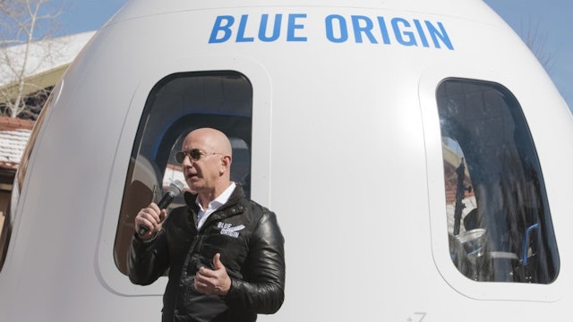 Jeff Bezos, chief executive officer of Amazon.com Inc. and founder of Blue Origin LLC, speaks at the unveiling of the Blue Origin New Shepard system during the Space Symposium in Colorado Springs, Colorado, U.S., on Wednesday, April 5, 2017. Bezos has been reinvesting money he made at Amazon since he started his space exploration company more than a decade ago, and has plans to launch paying tourists into space within two years. Photographer: