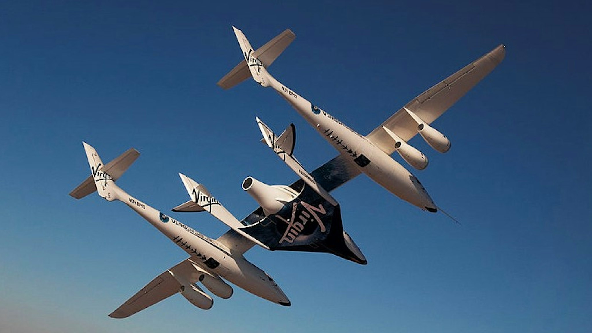 MOJAVE, UNITED STATES - JULY 15: (EDITORIAL USE ONLY, NO SUBJECT SPECIFIC TV BROADCAST DOCUMENTARIES OR BOOK USE) Virgin Galactic vehicles WhiteKnightTwo and SpaceShipTwo in flight during captive carry test flight at Mojave on July 15, 2010 in California. (Photo by
