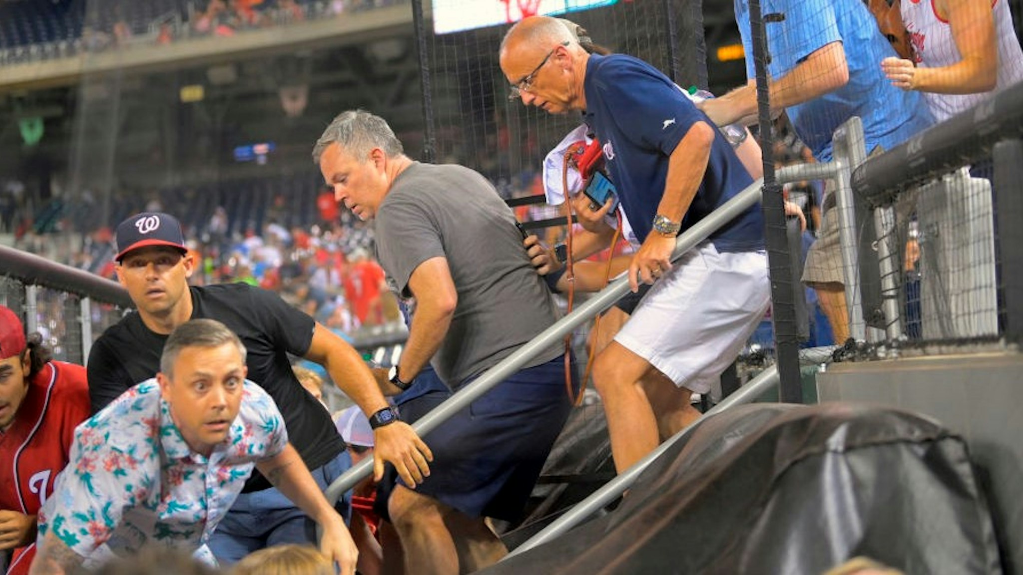 WASHINGTON, DC- JULY 17: Fans rush to evacuate after hearing during a game between a the San Diego Padres and the Washington Nationals at Nationals Park in Washington, DC on July 17, 2021. (Photo by