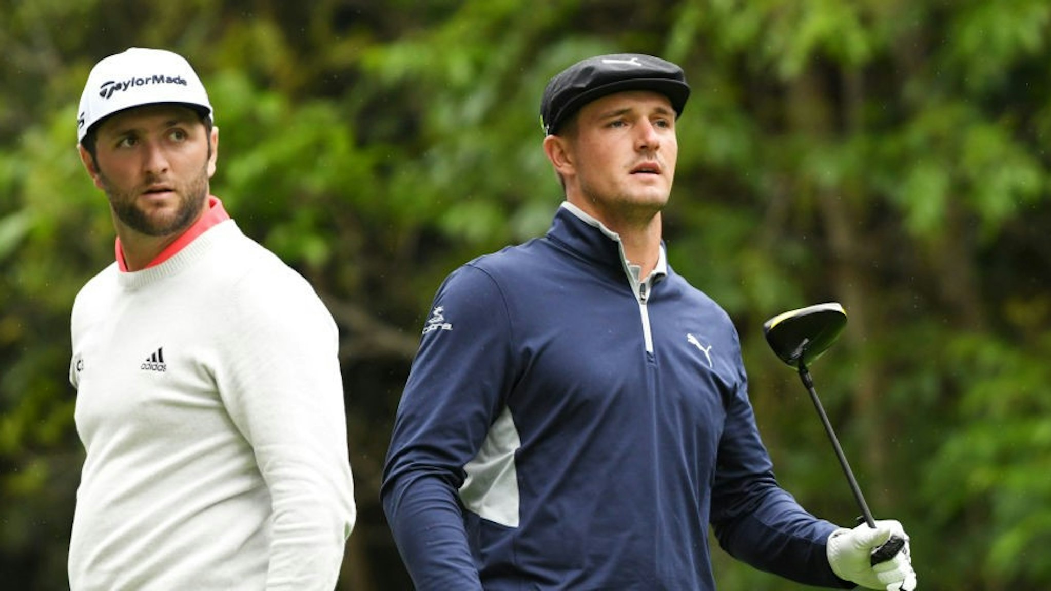 PACIFIC PALISADES, CALIFORNIA - FEBRUARY 15: Jon Rahm of Spain (L) and Bryson DeChambeau watch a tee shot on the 12th hole during the second round of the Genesis Open at Riviera Country Club on February 15, 2019 in Pacific Palisades, California. (Photo by