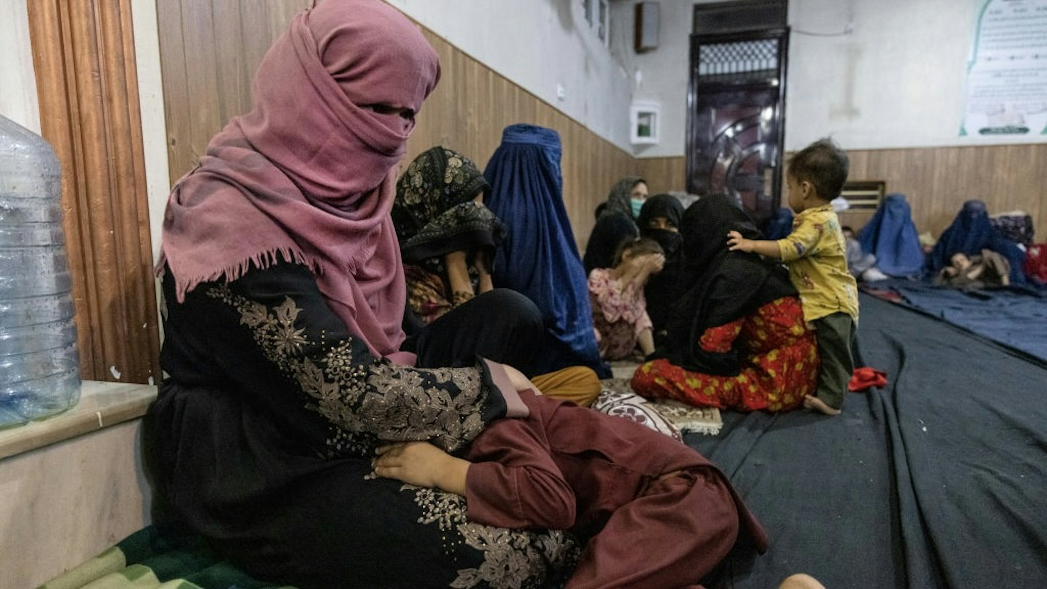 More Displaced Afghans Arrive In Kabul As Taliban Gains Ground KABUL, AFGANISTAN - AUGUST 13 : Displaced Afghan women and children from Kunduz are seen at a mosque that is sheltering them on August 13, 2021 in Kabul, Afghanistan. Tensions are high as the Taliban advance on the capital city after taking Herat and the country's second-largest city Kandahar. (Photo by Paula Bronstein /Getty Images) Paula Bronstein / Stringer via Getty Images