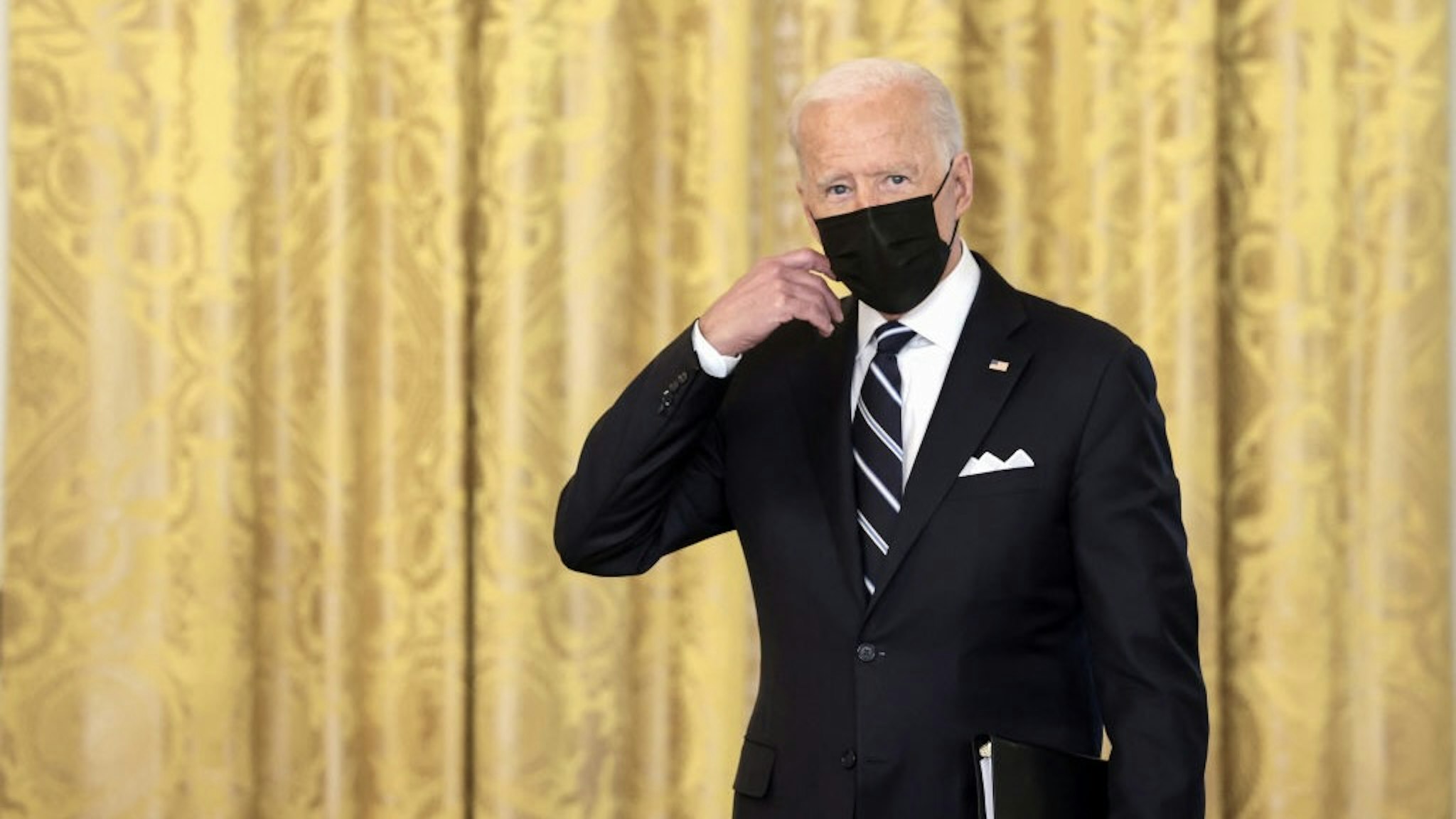 President Biden Delivers Remarks On Administration's Covid-19 Response WASHINGTON, DC - AUGUST 18: U.S. President Joe Biden removes his face mask as he arrives to deliver remarks on the COVID-19 response and the vaccination program in the East Room of the White House on August 18, 2021 in Washington, DC. During his remarks, President Biden announced that he is ordering the United States Department of Health and Human Services to require nursing homes to have vaccinated staff in order for them to receive Medicare and Medicaid funding. The President also announced that Americans would be able to receive a third booster shot against Covid-19. (Photo by Anna Moneymaker/Getty Images) Anna Moneymaker / Staff via Getty Images
