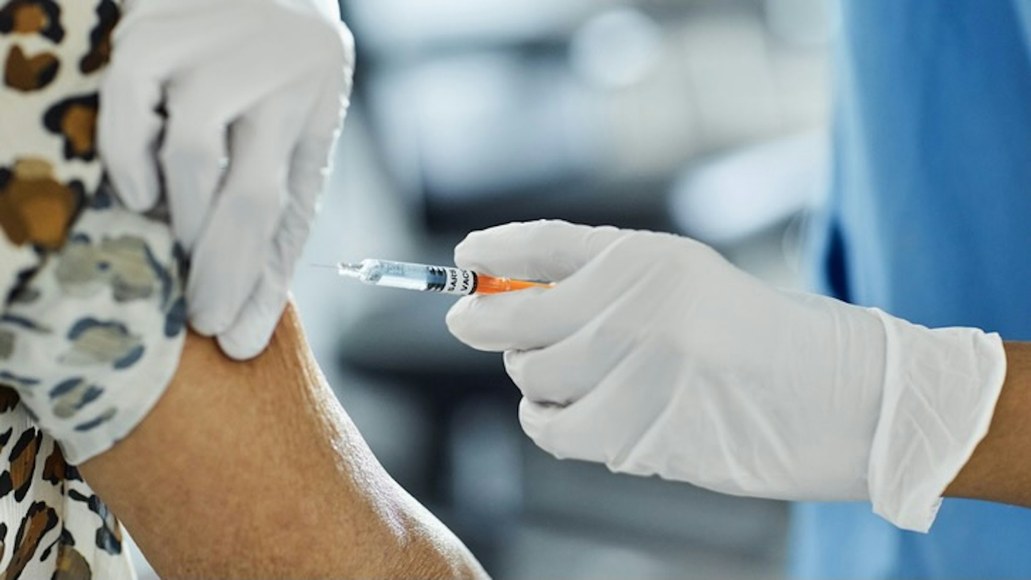 Spanish Hospital Administers Some Of The Country's First Covid-19 Vaccination Shots - stock photo Cropped image of nurse injecting Covid-19 Vaccine to a patient. Female healthcare worker is working at hospital. She is holding syringe. Morsa Images via Getty Images