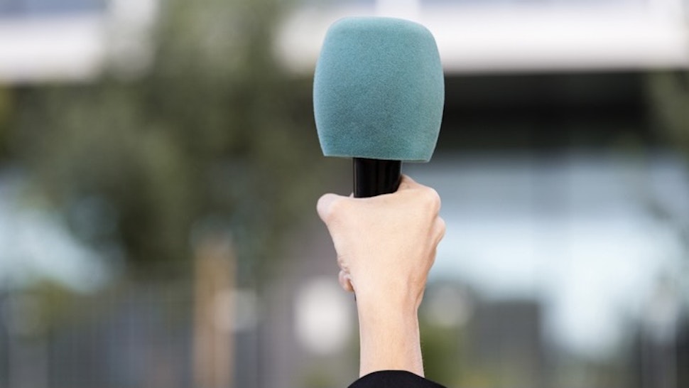 Close-up of a hand of a journalist holding a microphone latex gloves holding a microphone with plastic protection- stock photo - stock photo Close-up of a hand of a journalist holding a microphone latex gloves holding a microphone with plastic protection Manu Vega via Getty Images