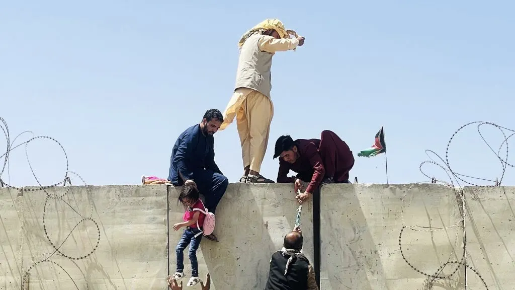 WATCH: Afghan Toddler Passed To American Soldiers Over Barbed Wire At Kabul Airport