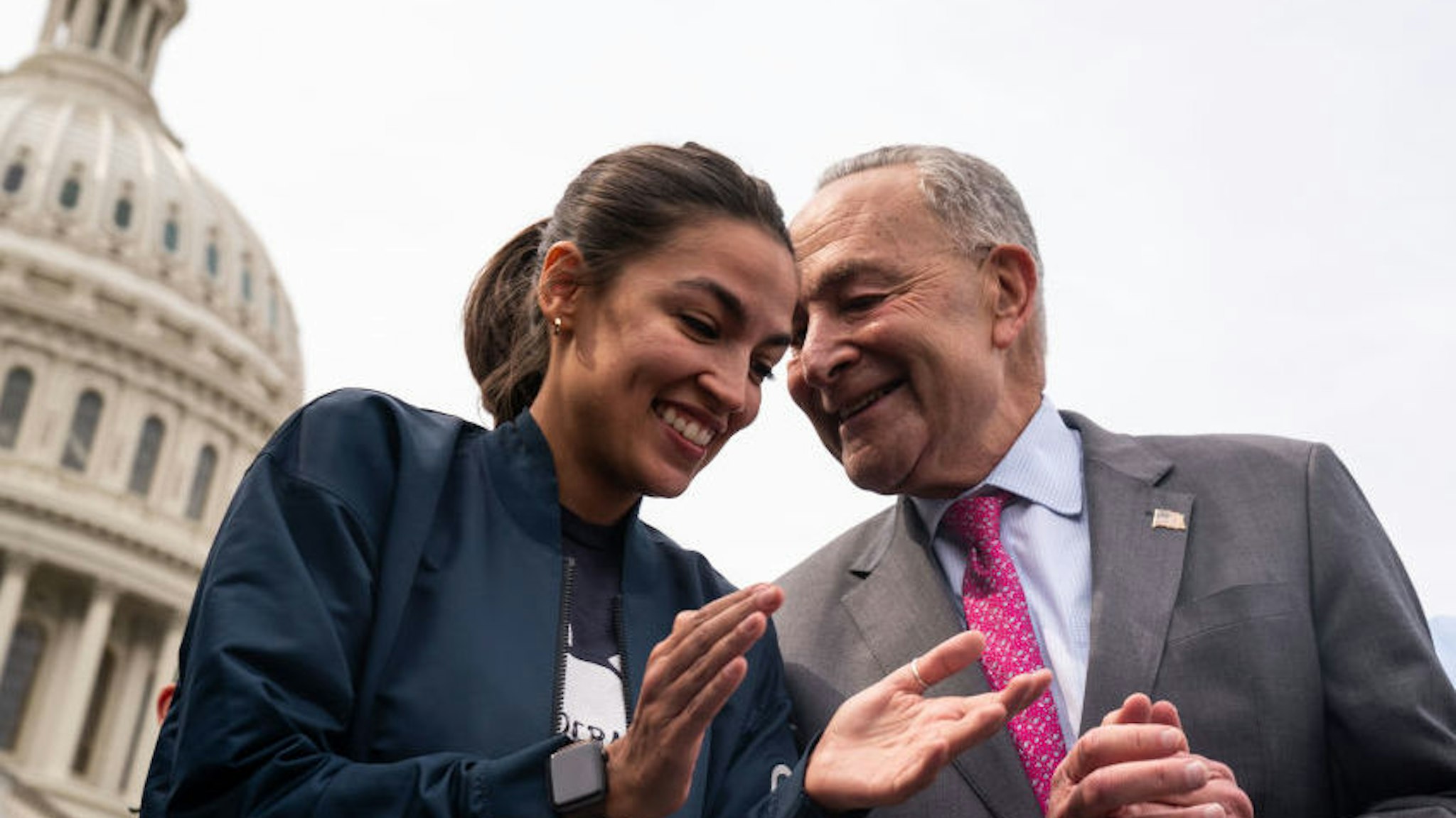 WASHINGTON, DC - AUGUST 03: Rep. Alexandria Ocasio-Cortez (D-NY) and Senate Majority Leader Chuck Schumer (D-NY) outside the House of Representatives while speaking to members of the press on Capitol Hill on Tuesday, Aug. 3, 2021 in Washington, DC. (