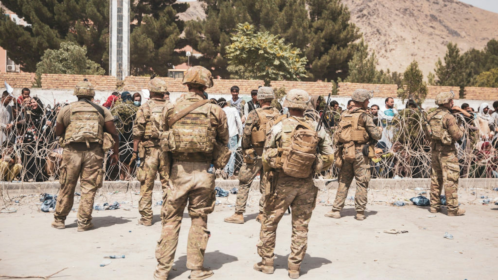 HAMID KARZAI INTERNATIONAL AIRPORT, AFGHANISTAN - AUGUST 19: This handout image shows U.S. Soldiers and Marines assist with security at an Evacuation Control Checkpoint during an evacuation at Hamid Karzai International Airport, August 19, 2021 in Kabul, Afghanistan. U.S. service members are assisting the Department of State with a non-combatant evacuation operation (NEO) in Afghanistan.