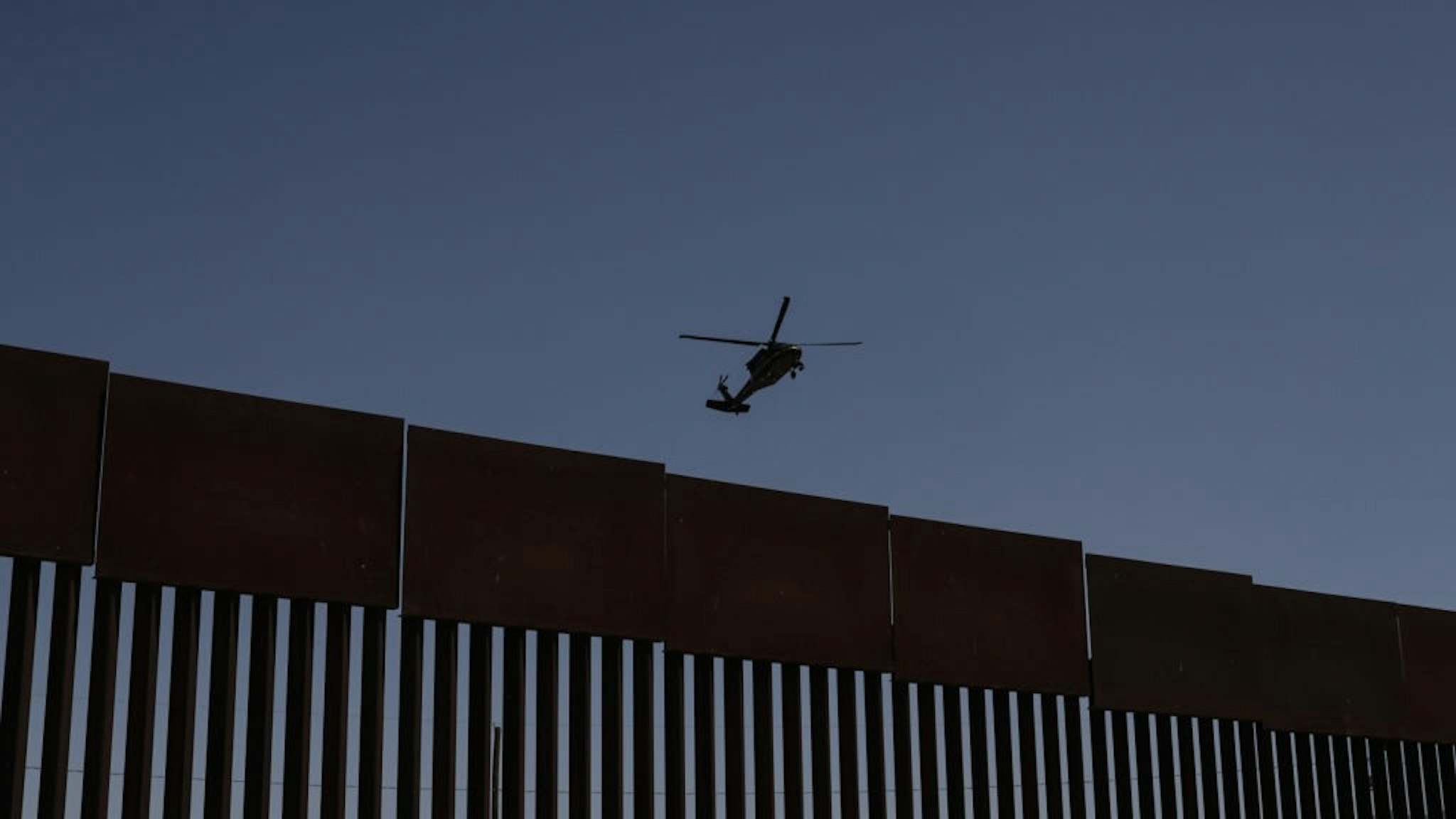 Mexico Faces Migrant Crisis With Few Resources A helicopter flies above a section of the U.S. and Mexico border wall in Ciudad Juarez, Mexico, on Wednesday, May 19, 2021. Shelters across Mexico are packed, amid reduced capacity because of the pandemic, and groups providing food and medical care strain to meet an acute need as the number of migrants grow, reports the Los Angeles Times. Photographer: Jonathan Alpeyrie/BloombergContributor via Getty Images