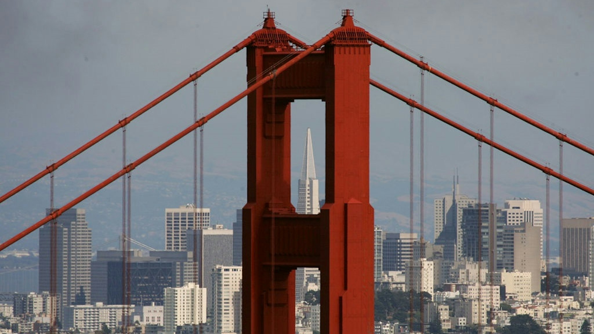 SAUSALITO, CA - JUNE 20: The Transamerica Pyramid building is seen through the north tower of the Golden Gate Bridge June 20, 2007 as seen from Sausalito, California.