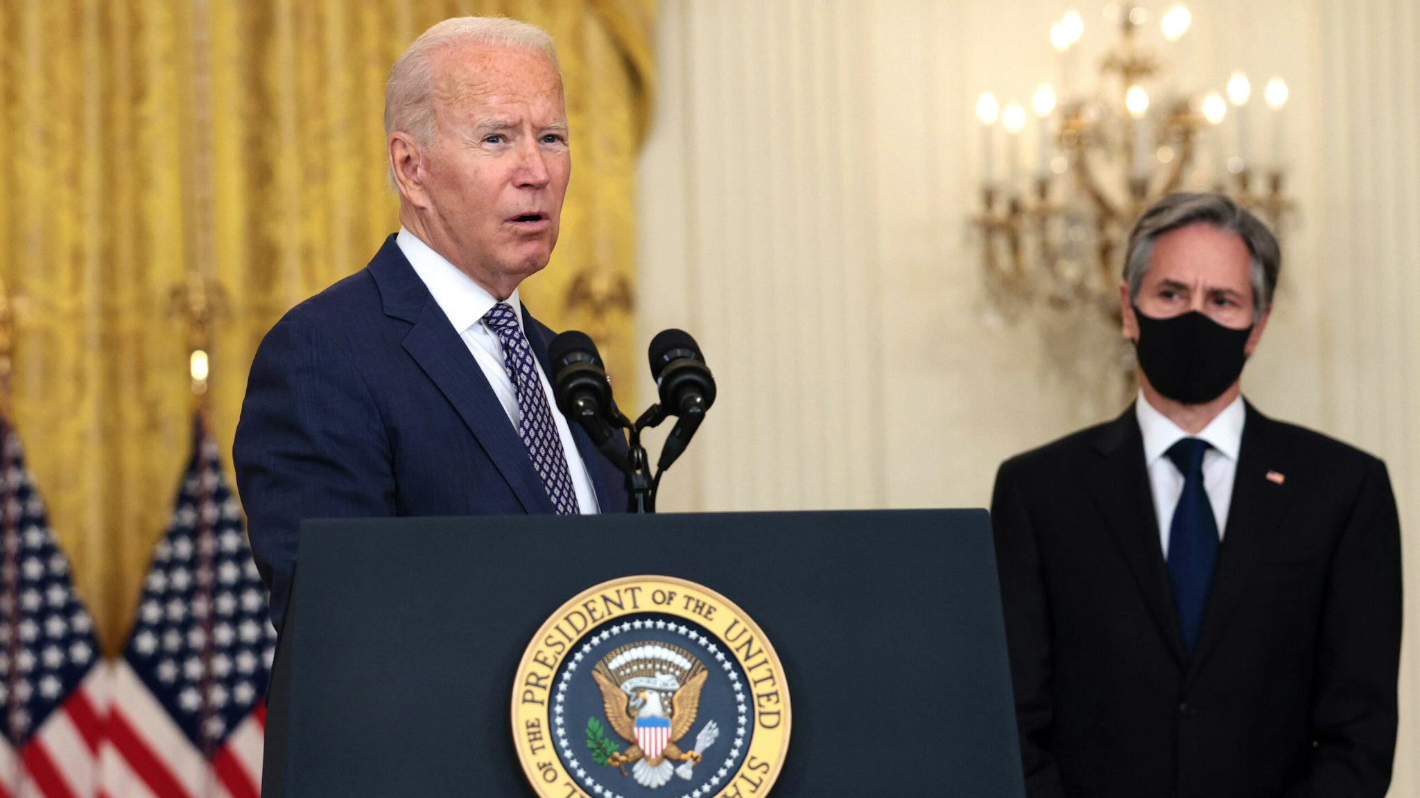 WASHINGTON, DC - AUGUST 20: U.S. President Joe Biden gestures to Secretary of State Antony Blinken as he gives remarks on the U.S. military’s ongoing evacuation efforts in Afghanistan from the East Room of the White House on August 20, 2021 in Washington, DC. The White House announced earlier that the U.S. has evacuated almost 14,000 people from Afghanistan since the end of July.