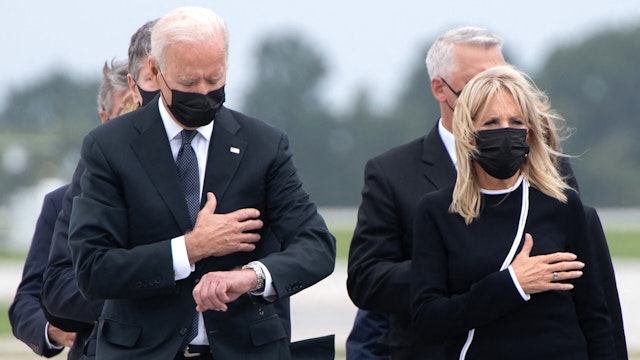 US President Joe Biden looks down alongside First Lady Jill Biden as they attend the dignified transfer of the remains of a fallen service member at Dover Air Force Base in Dover, Delaware, August, 29, 2021, one of the 13 members of the US military killed in Afghanistan last week. - President Joe Biden prepared Sunday at a US military base to receive the remains of the 13 American service members killed in an attack in Kabul, a solemn ritual that comes amid fierce criticism of his handling of the Afghanistan crisis. Biden and his wife, Jill, both wearing black and with black face masks, first met far from the cameras with relatives of the dead in a special family center at Dover Air Force Base in Delaware.The base, on the US East Coast about two hours from Washington, is synonymous with the painful return of service members who have fallen in combat.