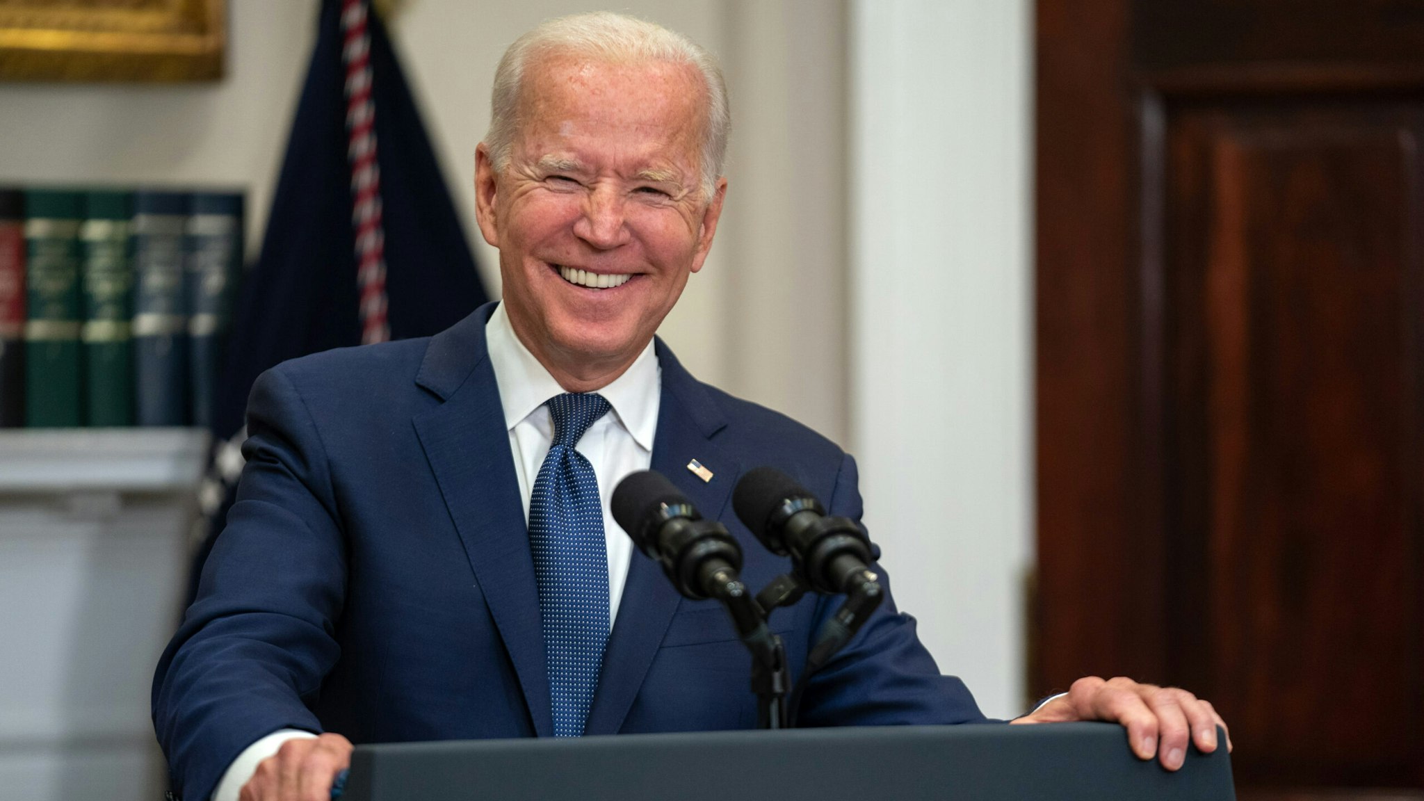 U.S. President Joe Biden smiles while speaking in the Roosevelt Room of the White House in Washington, D.C., U.S., on Sunday, Aug. 22, 2021. Biden said the U.S. has expanded its evacuation efforts beyond the perimeter of the Kabul airport, warned of possible terror attacks and acknowledged that he may be forced to push back his deadline for leaving Afghanistan.