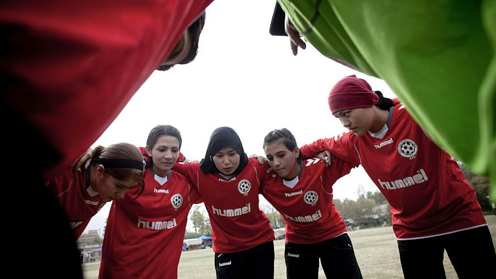 Afghan Women's National Football Team Play A Match Against The ISAF AFGHANISTAN, KABUL - OCTOBER 29: Members of the Afghan women's national football team huddles during a match with the NATO-led International Security Assistance Force (ISAF) women's team in a friendly football match at the ISAF headquarters in Kabul on October 29, 2010 in Kabul, Afghanistan. The Afghan women's team won 1-0. (Photo by Majid Saeedi/Getty Images) Majid Saeedi / Stringer via Getty Images