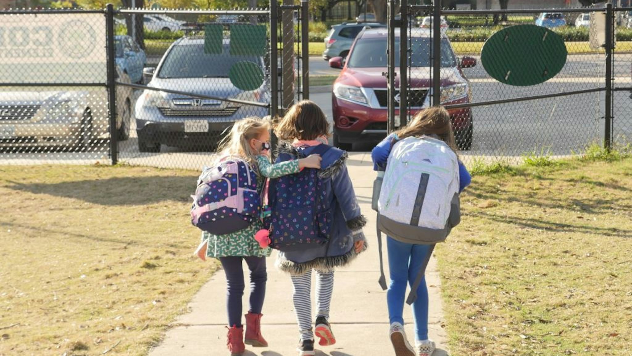 School children wearing facemasks walk outside Condit Elementary School in Bellaire, outside Houston, Texas, on December 16, 2020. - The coronavirus pandemic may be raging in the Houston area, but tens of thousands of students in one district are headed back to in-person classes in January because of poor results while learning from home. The plight of the town of Pasadena is being repeated across America, as educators fret that online learning for children because of the health crisis simply might not work. (Photo by François Picard / AFP) (Photo by FRANCOIS PICARD/AFP via Getty Images)