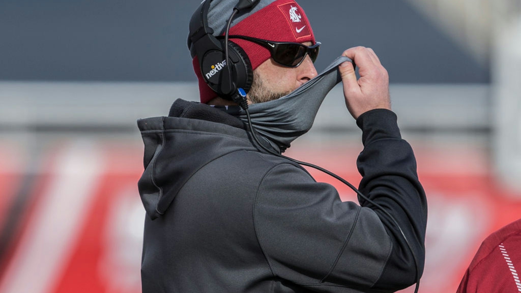 SALT LAKE CITY, UT - DECEMBER 19: Nick Rolovich head coach of the Washington State Cougars adjusts his mask during their game against the Utah Utes on December 19, 2020 at Rice Eccles Stadium in Salt Lake City, Utah. (Photo by Chris Gardner/Getty Images)