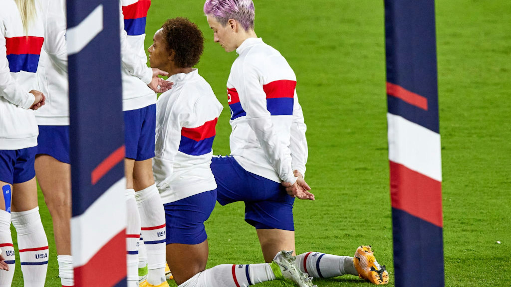 ORLANDO, FL - JANUARY 18: Several United States players including United States forward Megan Rapinoe (15) and United States defender Crystal Dunn (19) are seen taking a kneel during the singing of the national anthem in action during an International friendly match between United States and Colombia on January 18, 2021, at Explora Stadium in Orlando, FL. (Photo by Robin Alam/Icon Sportswire via Getty Images)