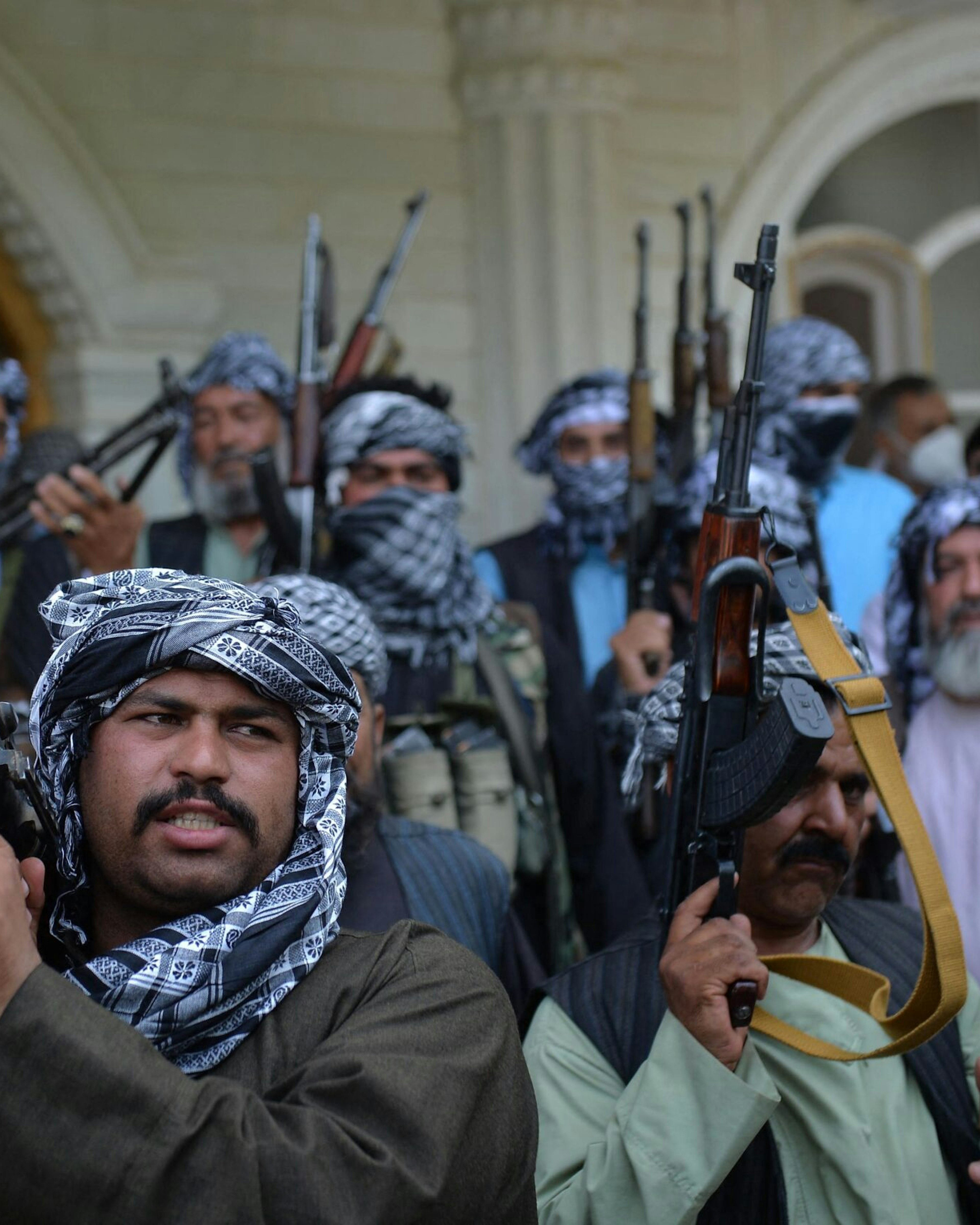 TOPSHOT - Afghan militia gather with their weapons to support Afghanistan security forces against the Taliban, in Afghan warlord and former Mujahideen leader Ismail Khan's house in Herat on July 9, 2021. (Photo by Hoshang HASHIMI / AFP) (Photo by HOSHANG HASHIMI/AFP via Getty Images)