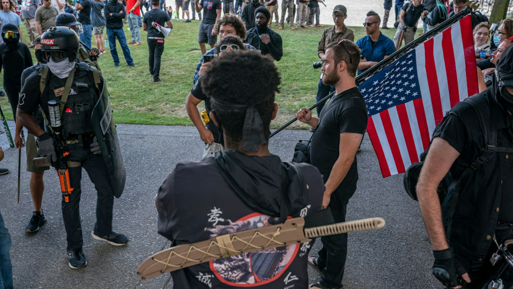 PORTLAND, OR - AUGUST 08: Far-right extremists and anti-fascists argue on August 8, 2021 in Portland, Oregon. The two groups clashed near a religious gathering in downtown Portland for the second day in a row without a police response.