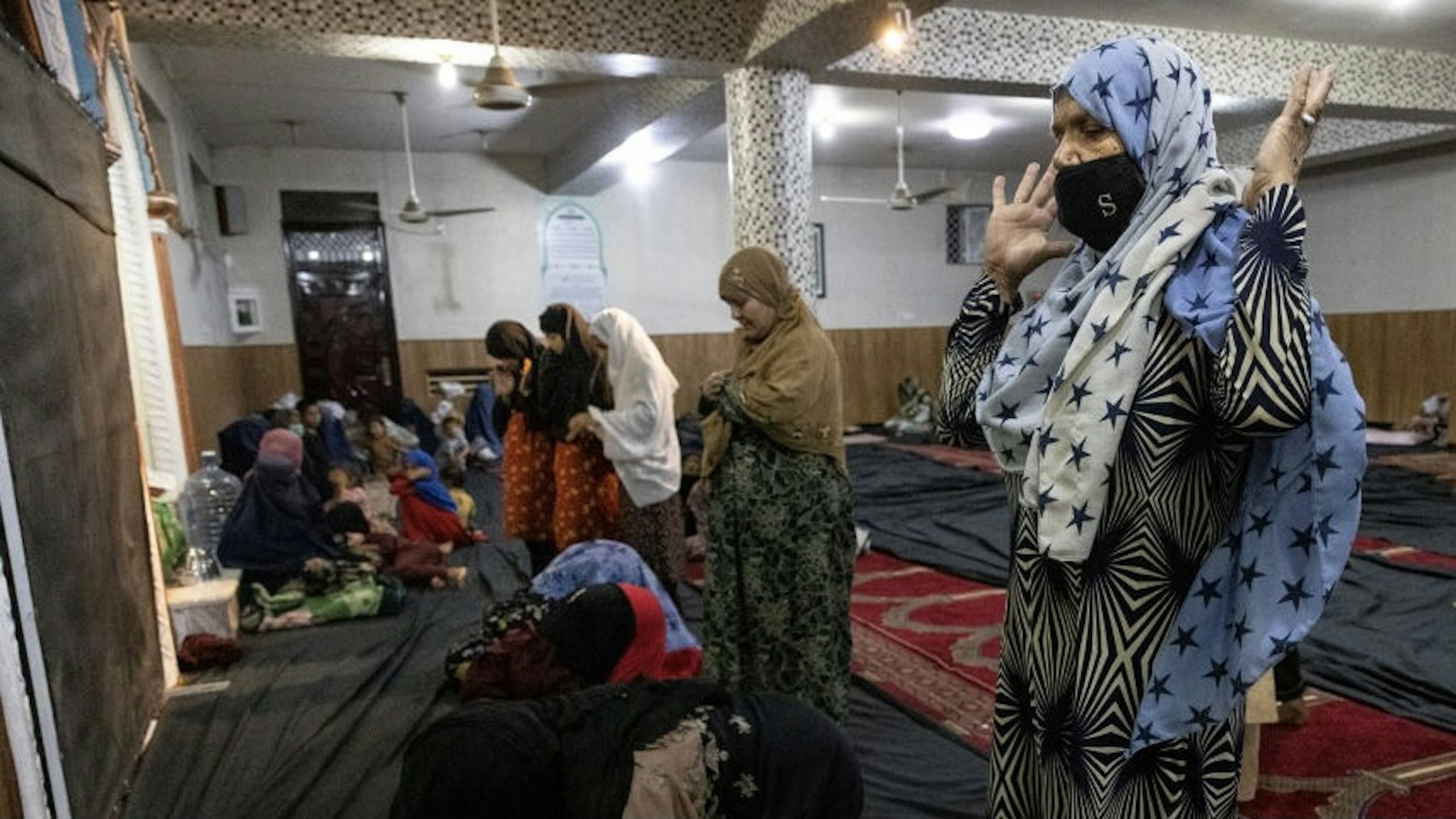 More Displaced Afghans Arrive In Kabul As Taliban Gains Ground KABUL, AFGANISTAN - AUGUST 13 : Displaced Afghan women and children from Kunduz pray at a mosque that is sheltering them on August 13, 2021 in Kabul, Afghanistan. Tensions are high as the Taliban advance on the capital city after taking Herat and the country's second-largest city Kandahar. (Photo by Paula Bronstein /Getty Images) Paula Bronstein / Stringer via Getty Images