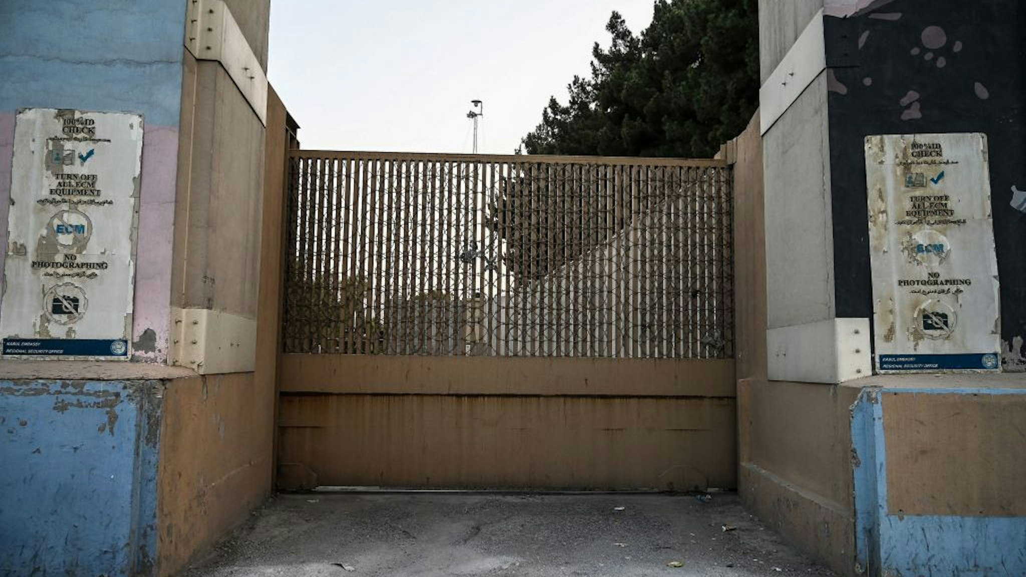 The closed entrance gate of the US embassy is pictured after the US evacuated its personnel in Kabul on August 15, 2021. (Photo by WAKIL KOHSAR / AFP) (Photo by WAKIL KOHSAR/AFP via Getty Images)