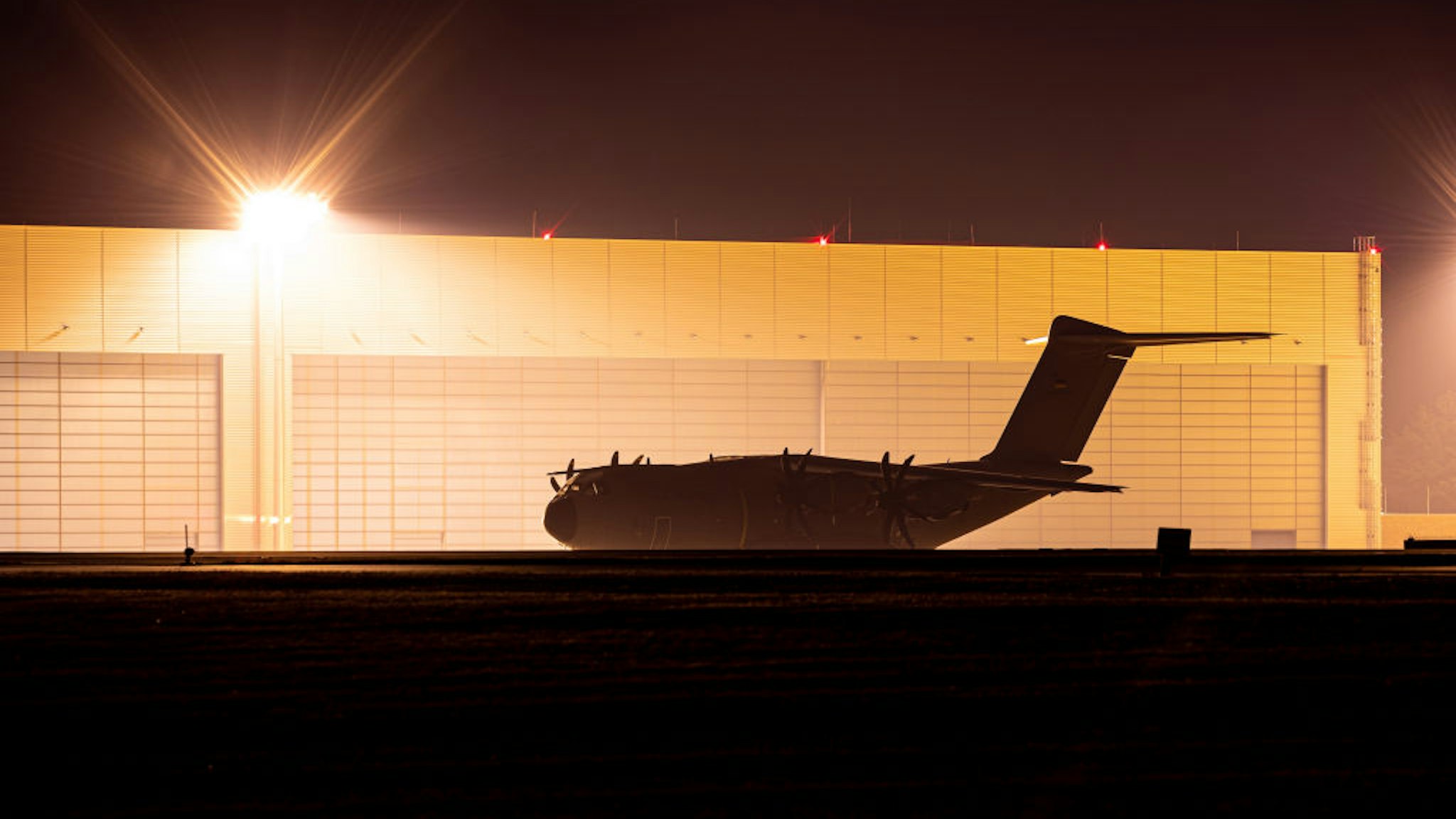 16 August 2021, Lower Saxony, Wunstorf: An Airbus A400M transport aircraft of the German Air Force stands at the Wunstorf air base in the Hanover region this evening. In view of the rapid advance of the Taliban in Afghanistan, the Bundeswehr plans to begin evacuating German citizens and local Afghan forces from Kabul on Monday (16.08.2021). Photo: Moritz Frankenberg/dpa (Photo by Moritz Frankenberg/picture alliance via Getty Images)