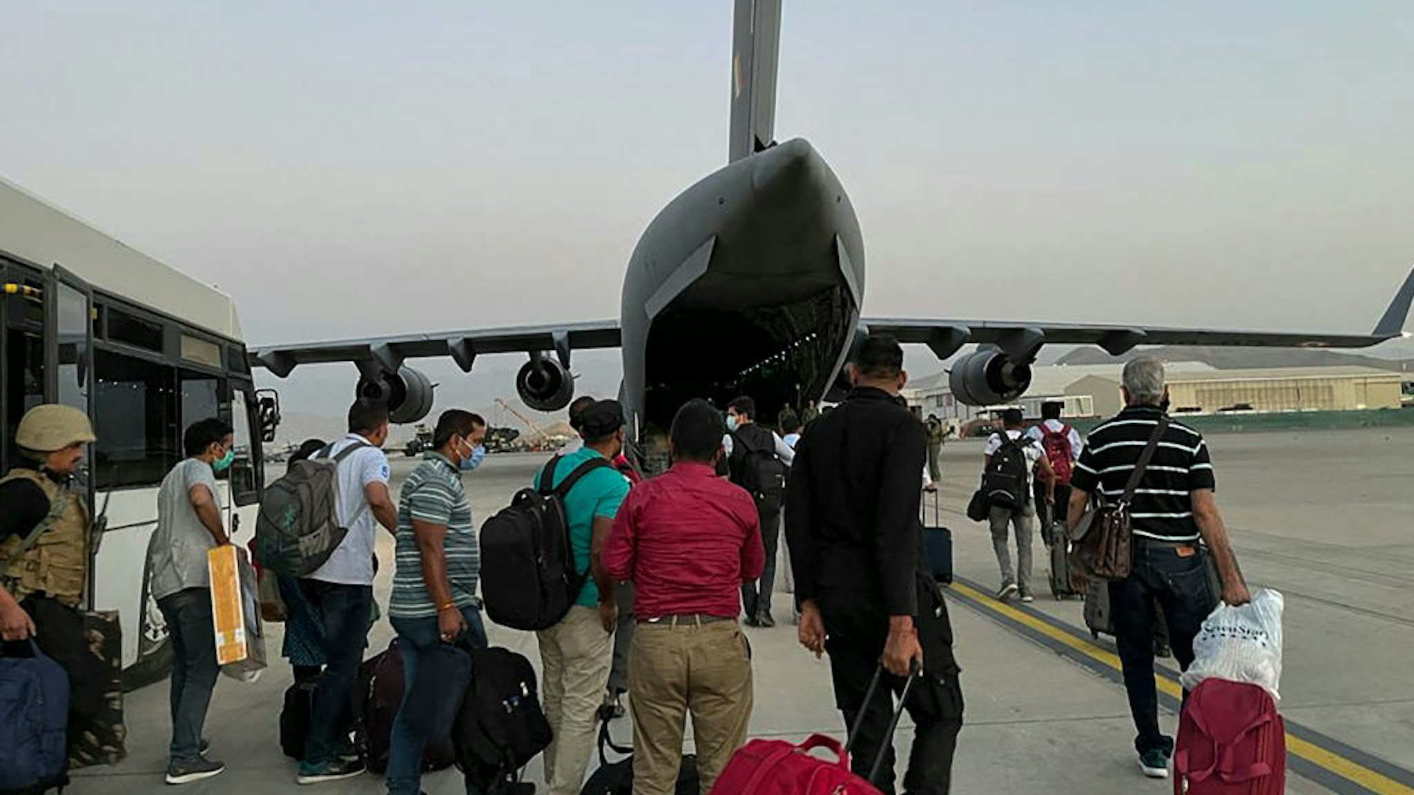 ndian nationals prepare to board an Indian military aircraft at the airport in Kabul on August 17, 2021 to be evacuated after the Taliban stunning takeover of Afghanistan. (Photo by STR / AFP) (Photo by STR/AFP via Getty Images)